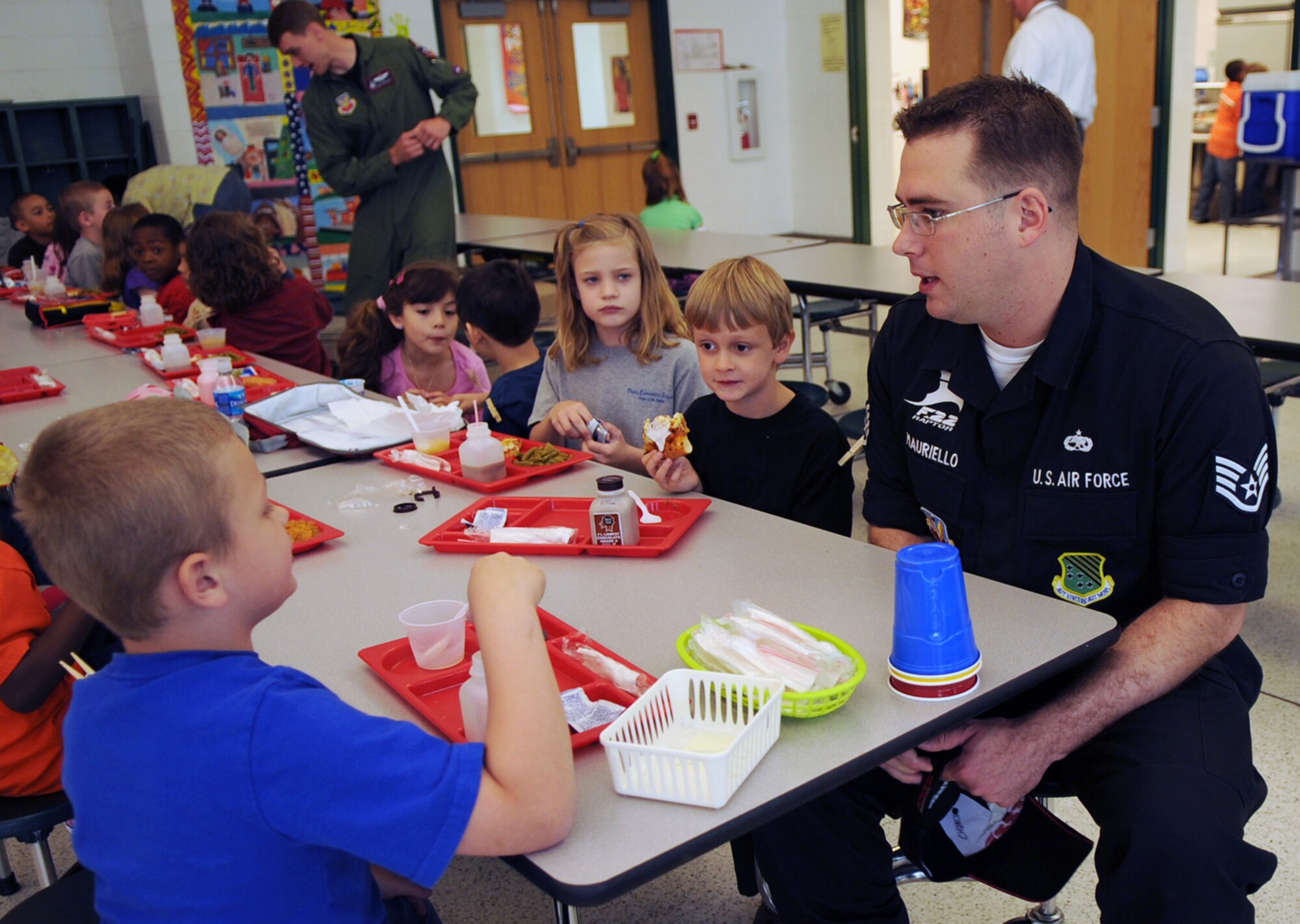 LANGLEY AIR FORCE BASE, Va. -- Staff Sgt. Michael Mauriello, F-22A Raptor Demonstration Team member, meets students at Thalia Elementary School in Virginia Beach April 22. The F-22 Demonstration Team visited schools throughout the local community as a part of Hampton Roads Air Force Week activities. This week is a chance to tell their Air Force story, showcase warfighting capabilities and thank the community for their support.  (U.S. Air Force photo/Staff Sgt. Tabitha Kuykendall)