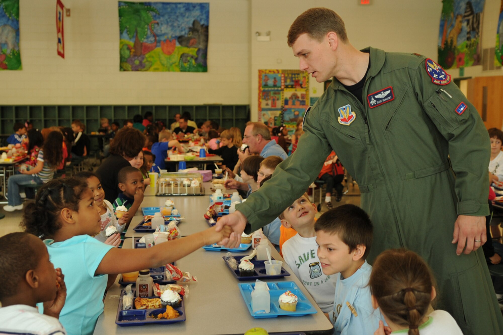 LANGLEY AIR FORCE BASE, Va. -- Maj. Dave "Zeke" Skalicky, F-22A Raptor Demonstration Team pilot, meets students  at Thalia Elementary School in Virginia Beach April 22. The F-22 Demonstration Team visited schools throughout the local community as a part of Hampton Roads Air Force Week activities. This week is a chance to tell their Air Force story, showcase warfighting capabilities and thank the community for their support.  (U.S. Air Force photo/Staff Sgt. Tabitha Kuykendall)