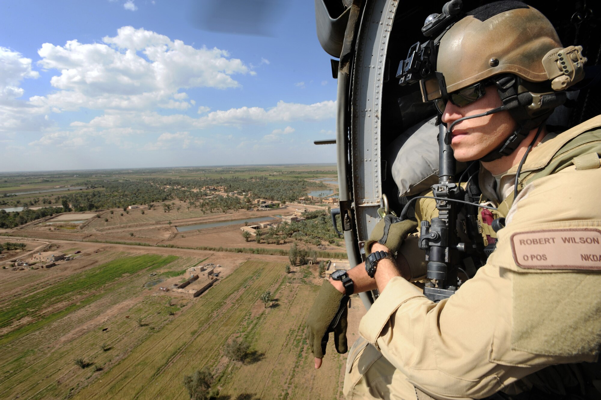 Capt. Robert Wilson scans for threats below during a mission April 10 in support of Operation Iraqi Freedom. He is a combat rescue officer assigned to the 64th Expeditionary Rescue Squadron at Joint Base Balad, Iraq, (U.S. Air Force photo/Staff Sgt. James L. Harper Jr.) 