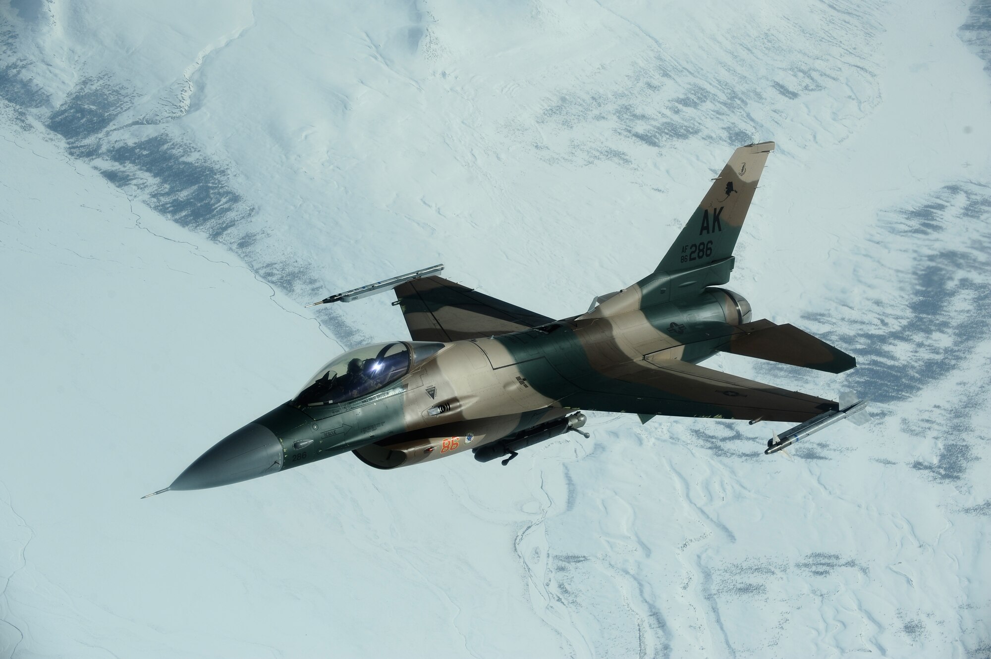 An F-16 Aggressor, 18th Aggressor Squadron, flies over the Joint Pacific Alaskan Range Complex during RED FLAG-Alaska 09-2 April 22, 2009, Eielson Air Force Base, Alaska. The 18th Aggressor Squadron acts as the opposing force during the exercise employing enemy tactics while engaging in aerial combat over the JPARC.  (U.S. Air Force Photo/Senior Airman Jonathan Snyder)
