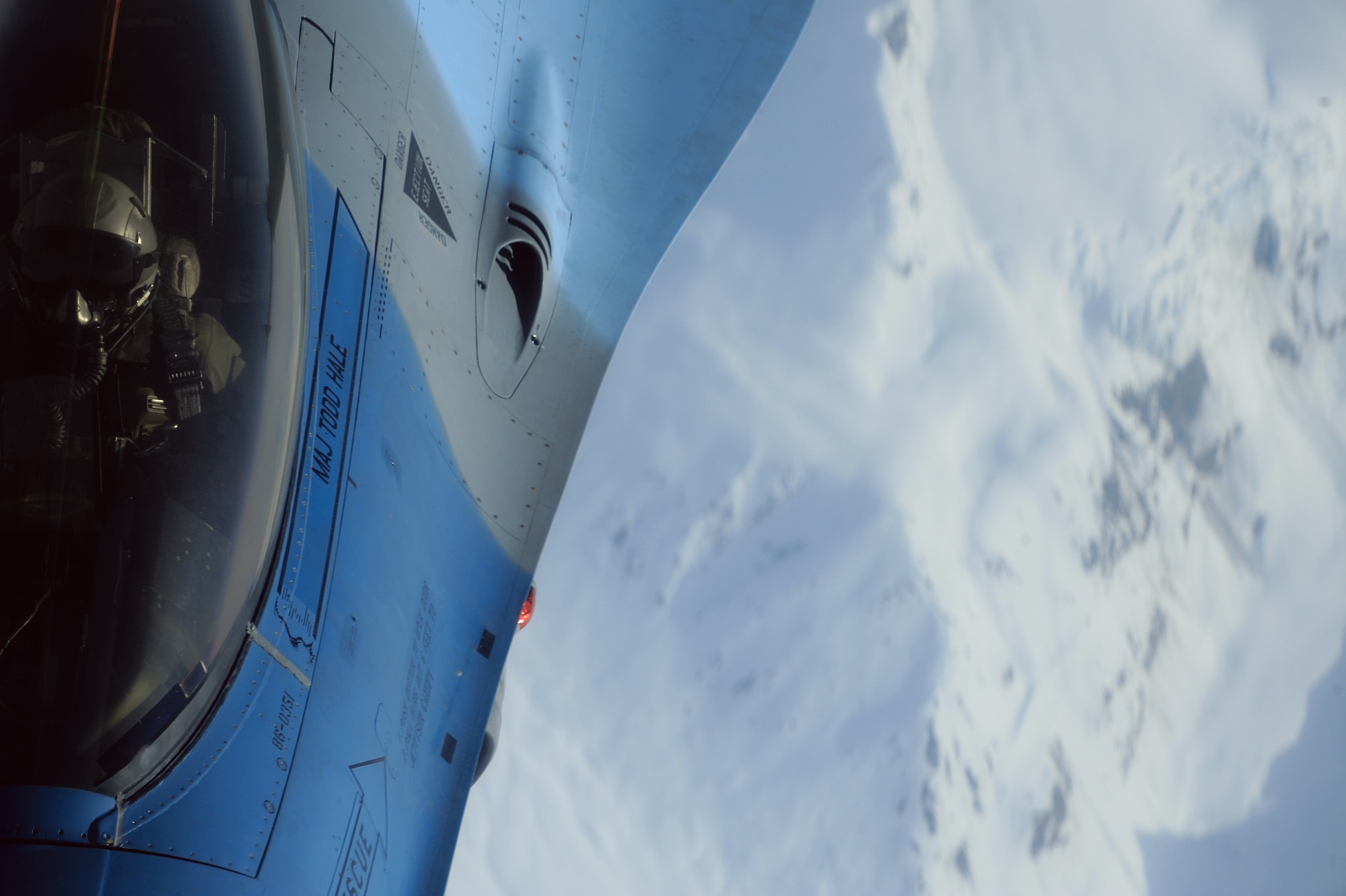 An F-16 Aggressor pilot, 18th Aggressor Squadron, watches the boom as it makes contact with his aircraft over the Joint Pacific Alaskan Range Complex during RED FLAG-Alaska 09-2 April 22, 2009, Eielson Air Force Base, Alaska. The Aggressor received fuel from a KC-10 Extender at 27,000 feet increasing the amount of time he can excute tactical aerial manuevers.  (U.S. Air Force Photo/Senior Airman Jonathan Snyder)
