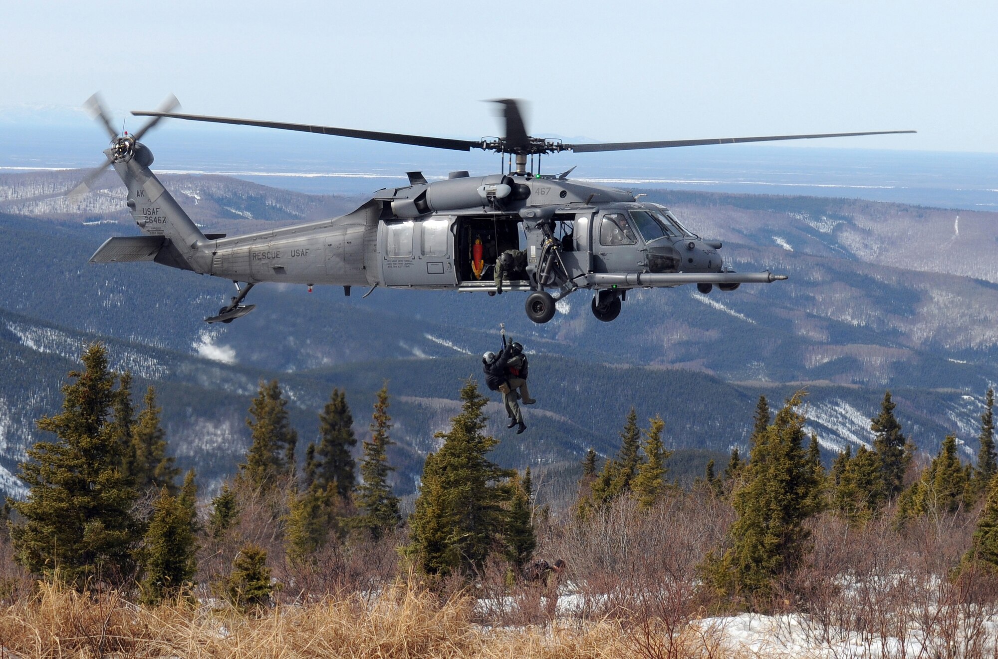 Airmen in a HH-60 Pavehawk from the 210th Rescue Squadron Detachment 1, rescue simulated downed pilots during Red-Flag Alaska 09-2 on April 22, 2009, Eielson Air Force Base, Alaska. RF-A provides realistic combat training which is essential to the success of air and space operations. (U.S. Air Force photo/Airman 1st Class Willard E. Grande II)