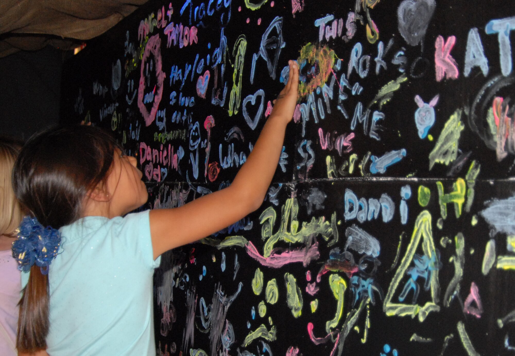 An Earth Day participant makes a cave drawing, similar to those of the Serrano's, a Native America Tribe who inhabited the loacal area. More than more than 2,000 people participated in Earth Day this year. (Air Force photo/Airman 1st Class William O'Brien)
