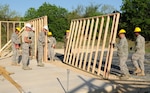 Reservists from the 433rd Flying Training Squadron and 556th Red Horse Squadron stationed at Lackland Air Force Base build shelters at Camp Van Ovost on the east side of Randolph. A latrine with showers and a decontamination building are also planned at the site to be used for combat training. (U.S. Air Force photo by Steve White)