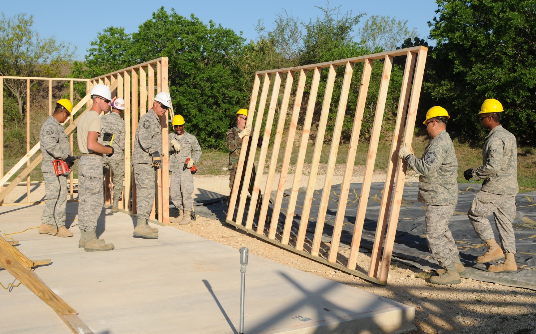 Reservists from the 433rd Flying Training Squadron and 556th Red Horse Squadron stationed at Lackland Air Force Base build shelters at Camp Van Ovost on the east side of Randolph. A latrine with showers and a decontamination building are also planned at the site to be used for combat training. (U.S. Air Force photo by Steve White)