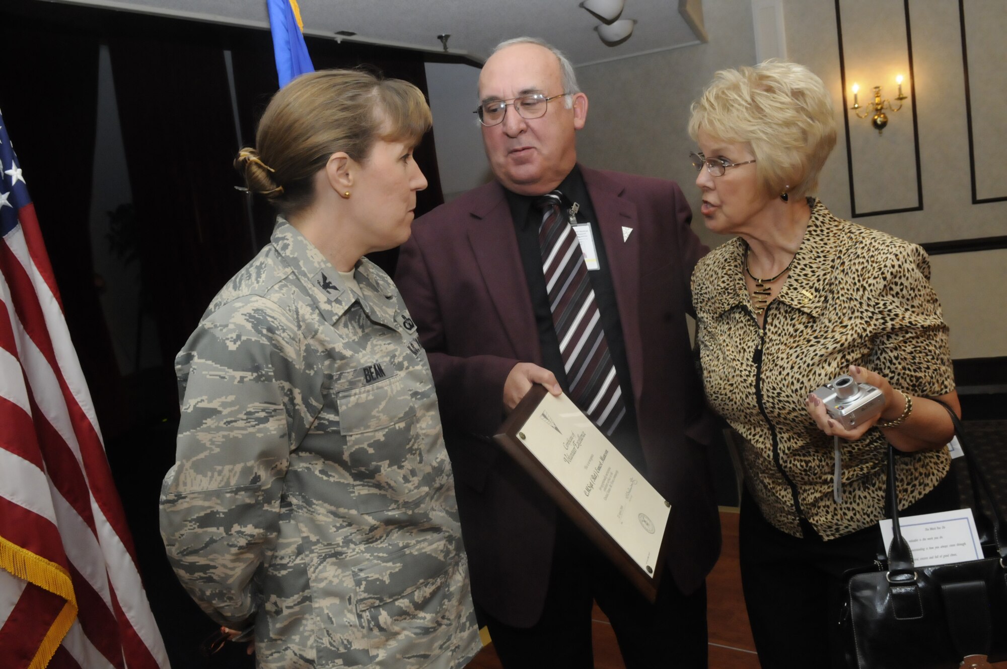 Col. Debra Bean, 78th Air Base Wing vice commander talks with retired CMSgt. Ernest Munson and his wife, Marie, after he received a Volunteer Excellence Award.  Robert Currey, Clyde Turner and Stephen Hoyt were also recipients of the award. U. S. Air Force photo by Sue Sapp