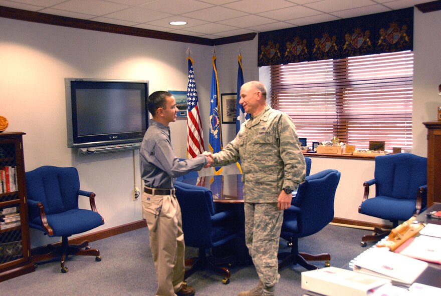Following his graduation from Officer Training School, newly commissioned 2nd Lt. Charles Glover stopped by Robins to thank Brig. Gen. Mark Atkinson, 402nd Maintenance Wing commander, for his endorsement. U.S. Air Force photo by Staff Sgt. Vann Miller