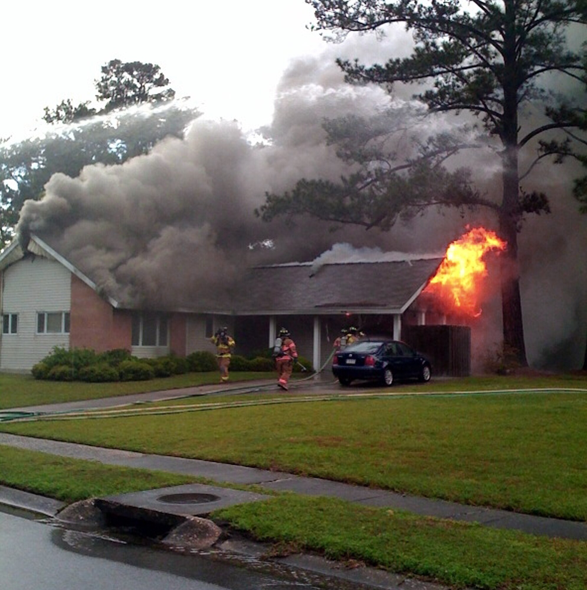 Members of the 437th Civil Engineer Squadron fire department at Charleston Air Force Base, S.C., respond to a fire April 20 at the base housing unit occupied by 1st Lt. Richard and Rachel Kerr. The Kerr's house caught fire after it was struck by lightning during a severe thunderstorm. (Courtesy Photo)
