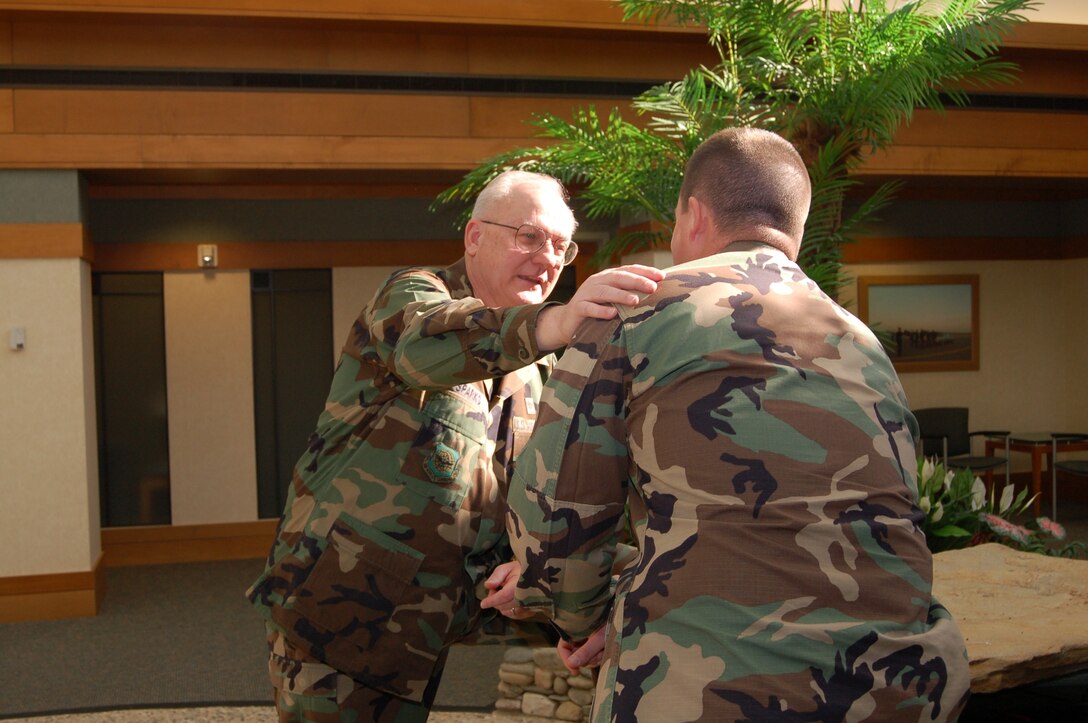 Chaplain (Lt. Col., ret.) David Sparks counsels a fellow Port Mortuary team member at Charles C. Carson Center for Mortuary Affairs at Dover Air Force Base, Del. Chaplain Sparks believes a chaplain goes through three stages once he assumes Port Mortuary duty: the horror stage, sadness stage, and focus stage. (U.S. Air Force photo/Tech. Sgt. Kevin Wallace) 