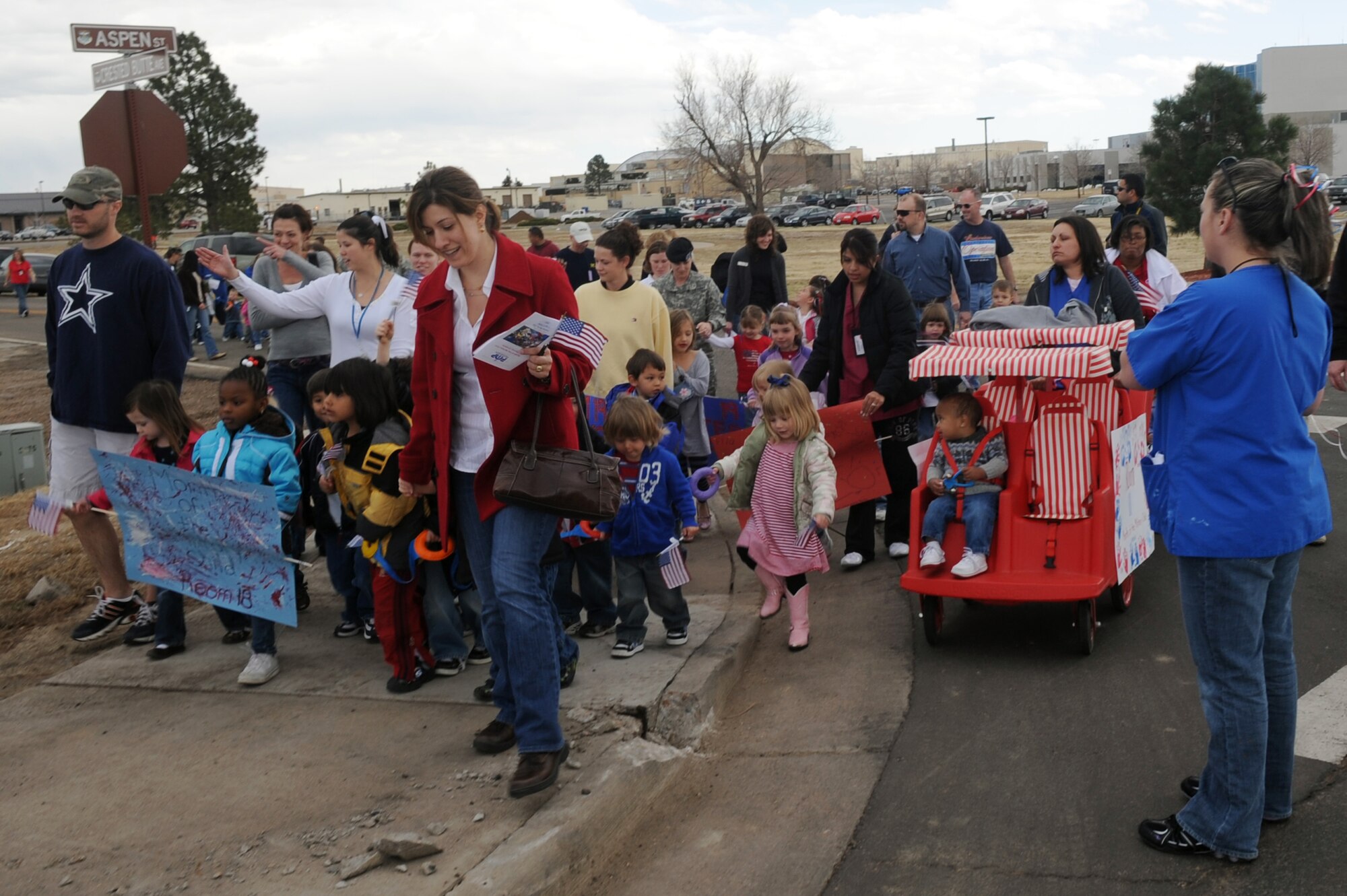 BUCKLEY AIR FORCE BASE, Colo. -- Children, parents and staff from both Child Development Centers participated in the kickoff parade for the Month of the Military Child here, April 3.  Many of the children dressed up in masks and face paint to walk in the parade.  The month of April is dedicated to the more than 1.7 million American children under the age of 18 that have at least one parent serving in the military.  (U.S. Air Force photo by Senior Airman John Easterling)