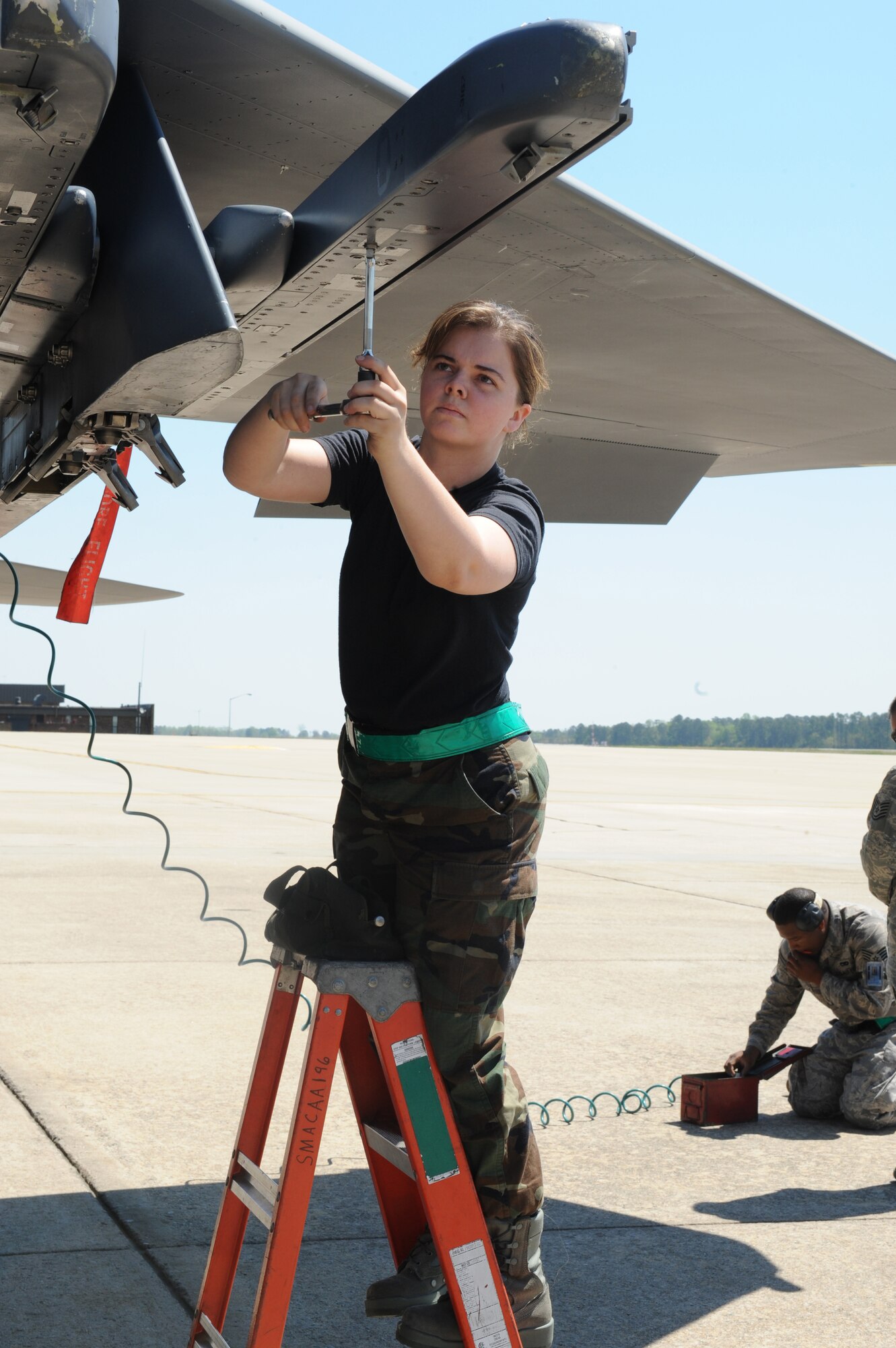 Airman 1st Class Stephanie Melson, 4th Aircraft Maintenance Squadron, prepares a missile launcher on an F-15E Strike Eagle during a load crew competition at Seymour Johnson Air Force Base, N.C., April 17, 2009. (U.S. Air Force photo by Airman 1st Class Whitney S. Lambert)