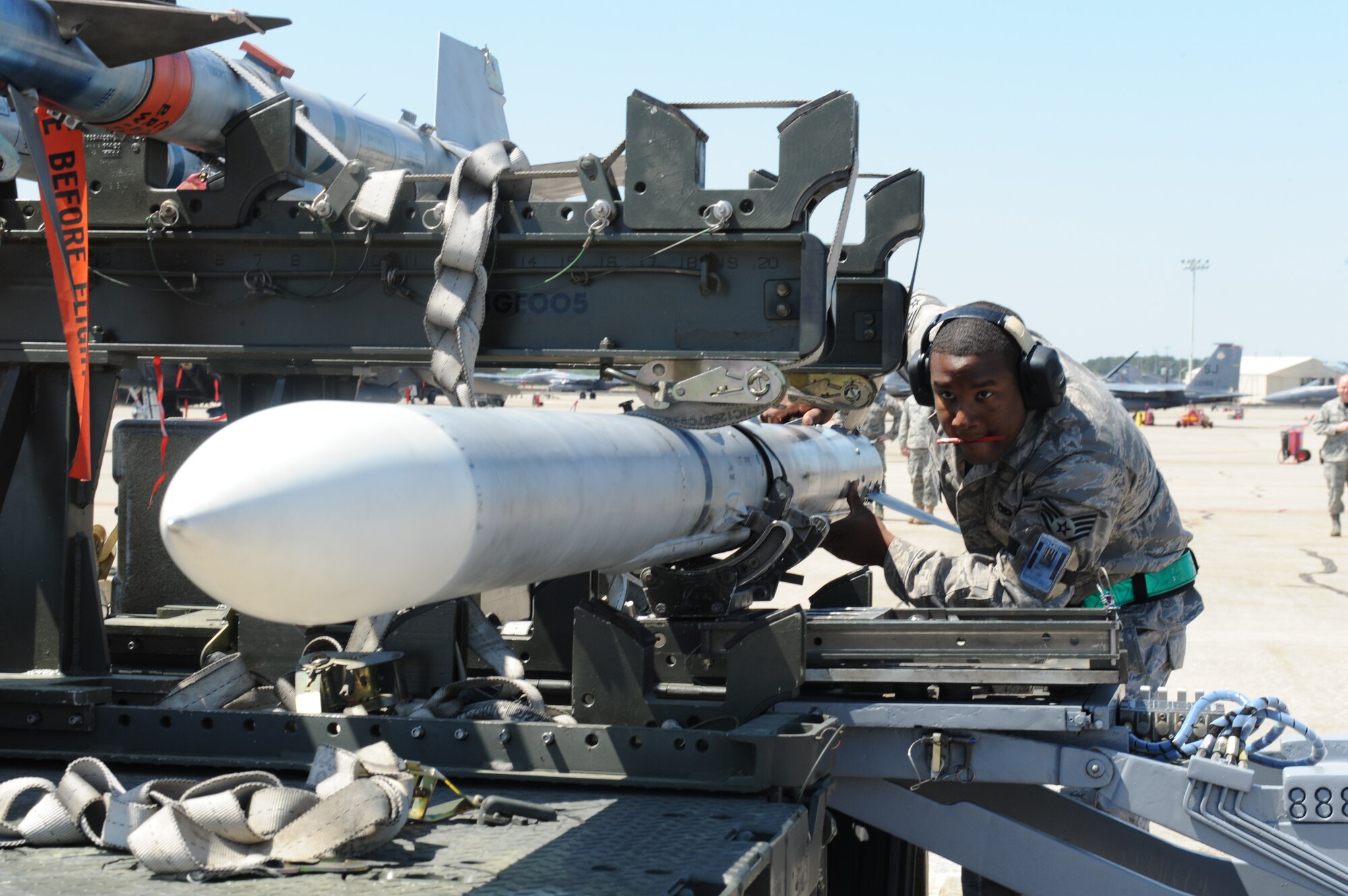 Staff Sgt. Thompson McAlister, 4th Aircraft Maintenance Squadron, inspects the placement of a missile on an MJ-1 weapons loader during a load crew competition at Seymour Johnson Air Force Base, N.C., April 17, 2009. The MJ-1 weapons loader, commonly known as a jammer, has served as the standard Air Force bomb-loading vehicle since the 1950s. (U.S. Air Force photo by Airman 1st Class Whitney S. Lambert)