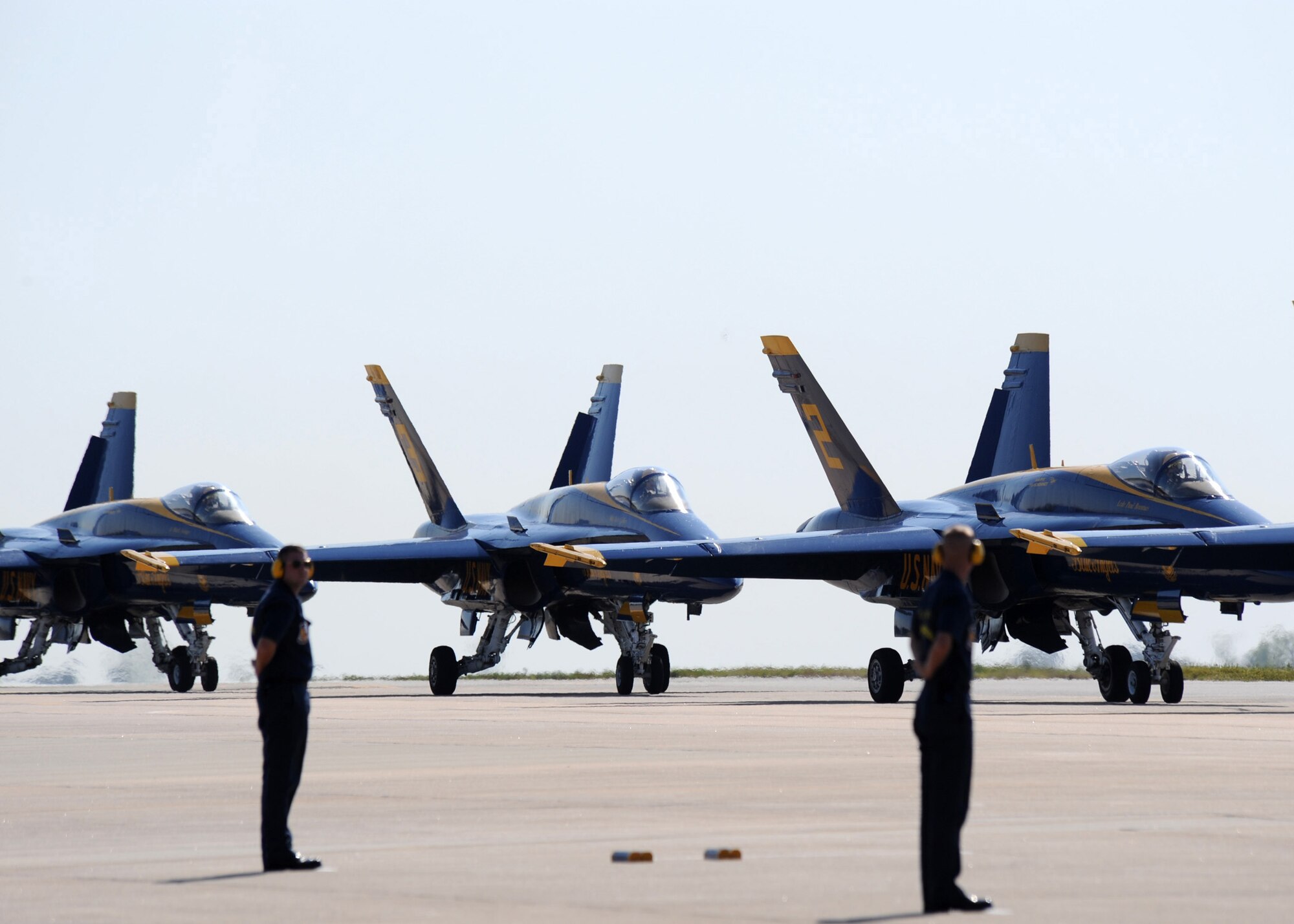 United States Navy Blue Angels crew chiefs marshal in their aircraft shortly after their arrival at Seymour Johnson Air Force Base, N.C., April 23, 2009. The Blue Angels will be the main attraction during the Wings over Wayne air show April 25 to 26. (U.S. Air Force photo by Senior Airman Makenzie Lang)