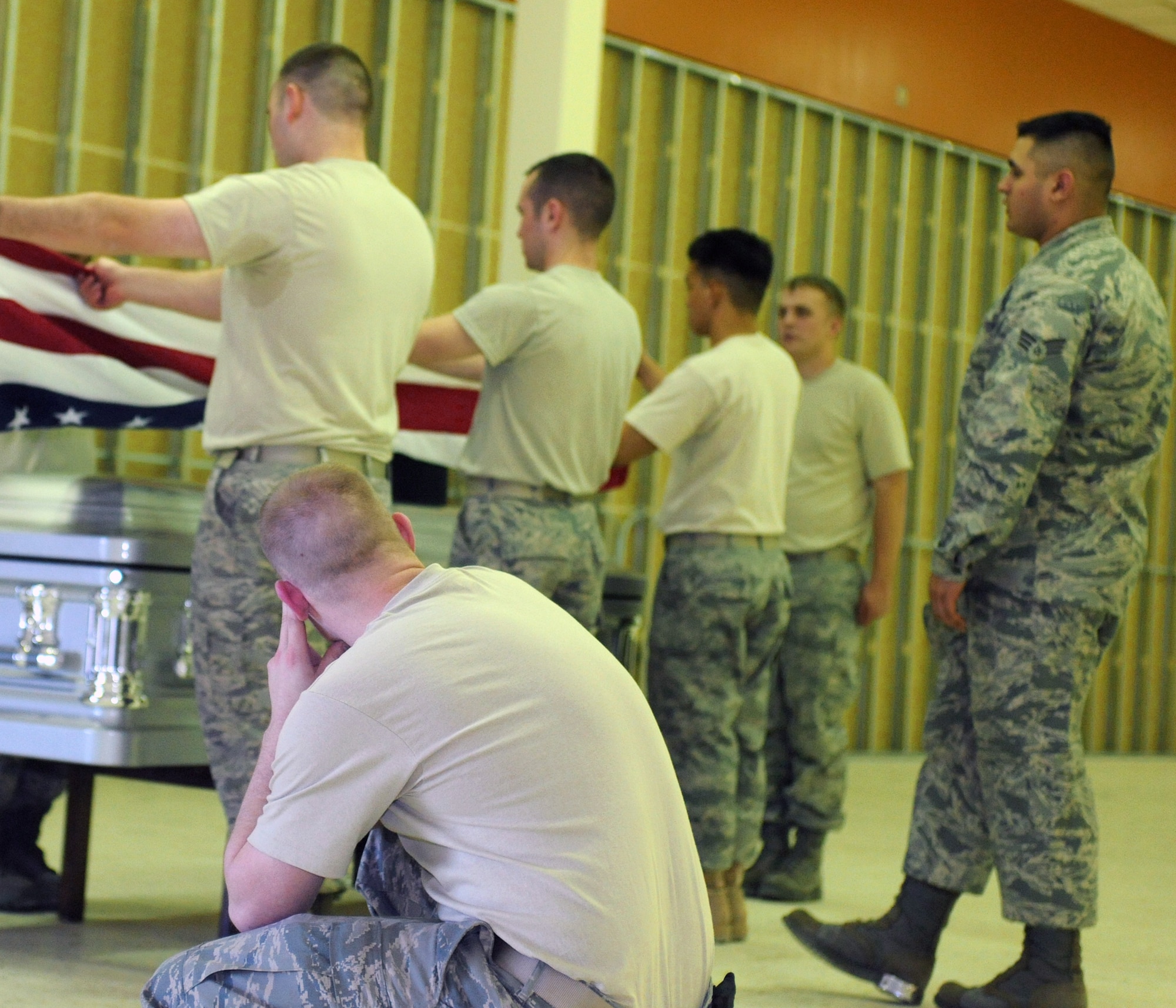 ELMENDORF AIR FORCE BASE, Alaska -- Members of the Elmendorf Honor Guard team receive training from members of the Air Force Honor Guard on Thursday, April 16. The group learns how to perfect their ceremonial skills during a burial. All members that passed the course graduated on Wednesday, April 22. (U.S. Air Force photo by Senior Airman Laura Turner)