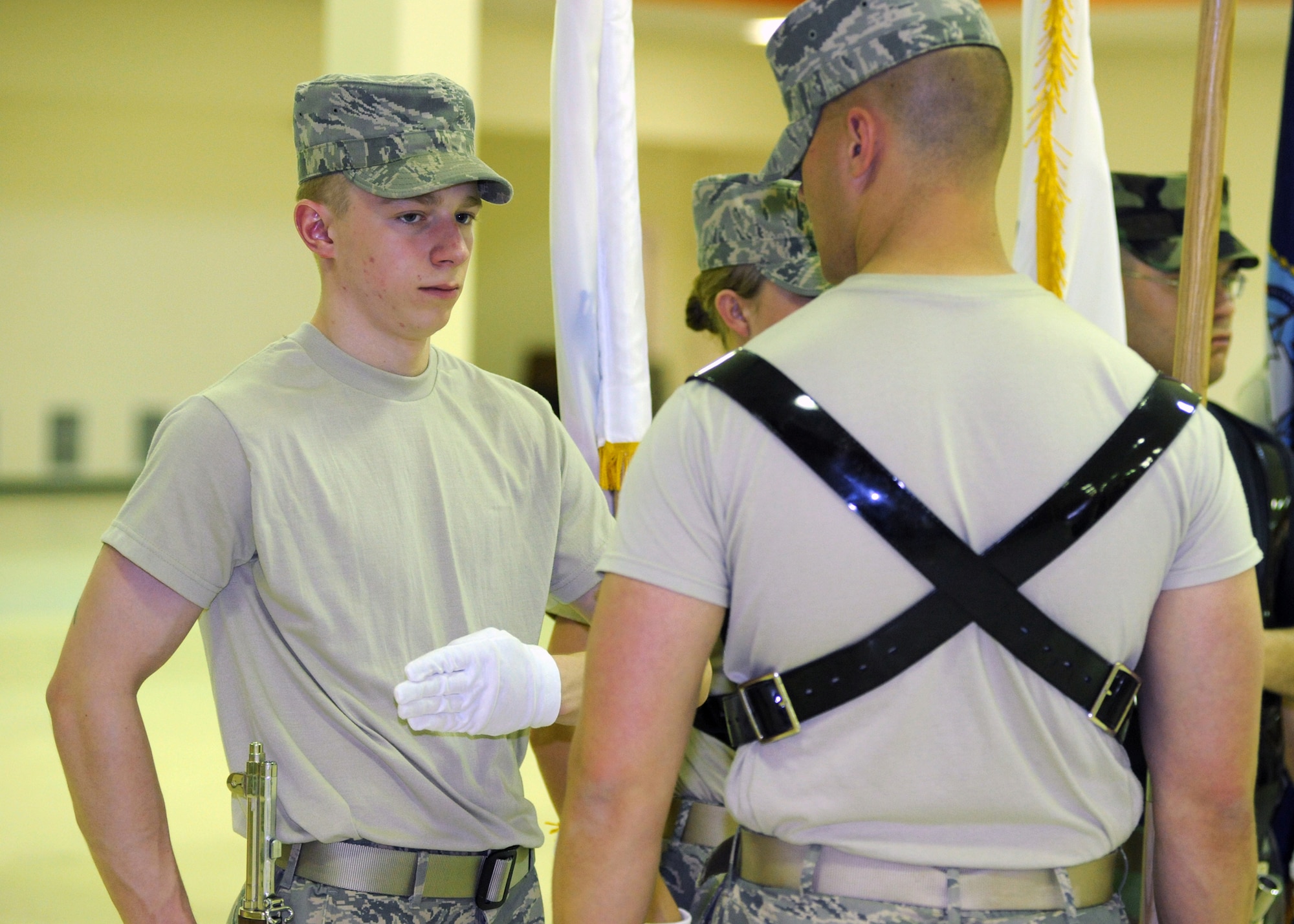 ELMENDORF AIR FORCE BASE, Alaska -- Airman Eric Scott receives training from Staff Sergeant Alex Frizzo on Thursday, April 16. SSgt Frizzo and other instructors from the Air Force Honor Guard taught members of the Elmendorf Honor Guard in funeral processions, salutes, and flag bearing. (U.S. Air Force photo by Senior Airman Laura Turner)