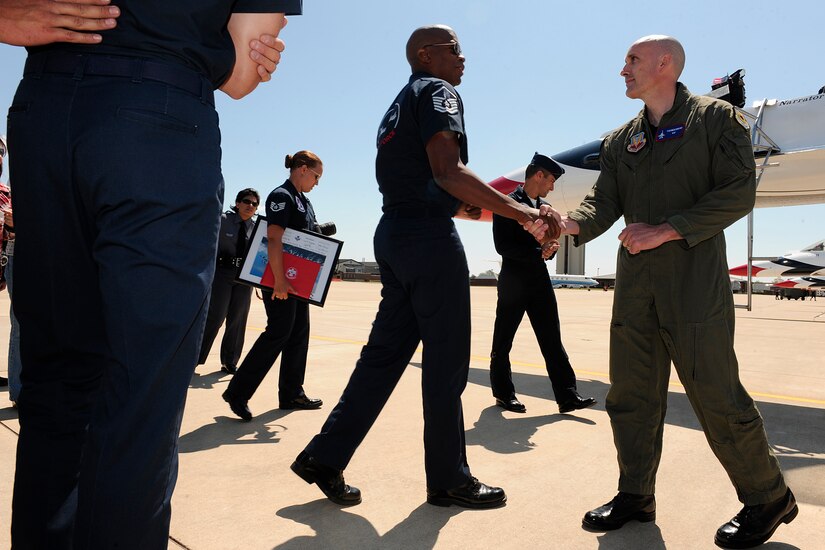 LANGLEY AIR FORCE BASE, Va. --  Master Sgt. Quincy Gordon, Thunderbirds aircraft section chief, shakes hands with Trooper Kurt Johnson, Virginia State Police, after his hometown hero flight here April 23. Trooper Johnson was awarded a hometown hero certificate along with a flight for saving a little girl from a burning car on her third birthday.  "I didn't even think; if it were one of my sons, I would've done the same thing," said Trooper Johnson.   (U.S. Air Force photo/Senior Airman Vernon Young)