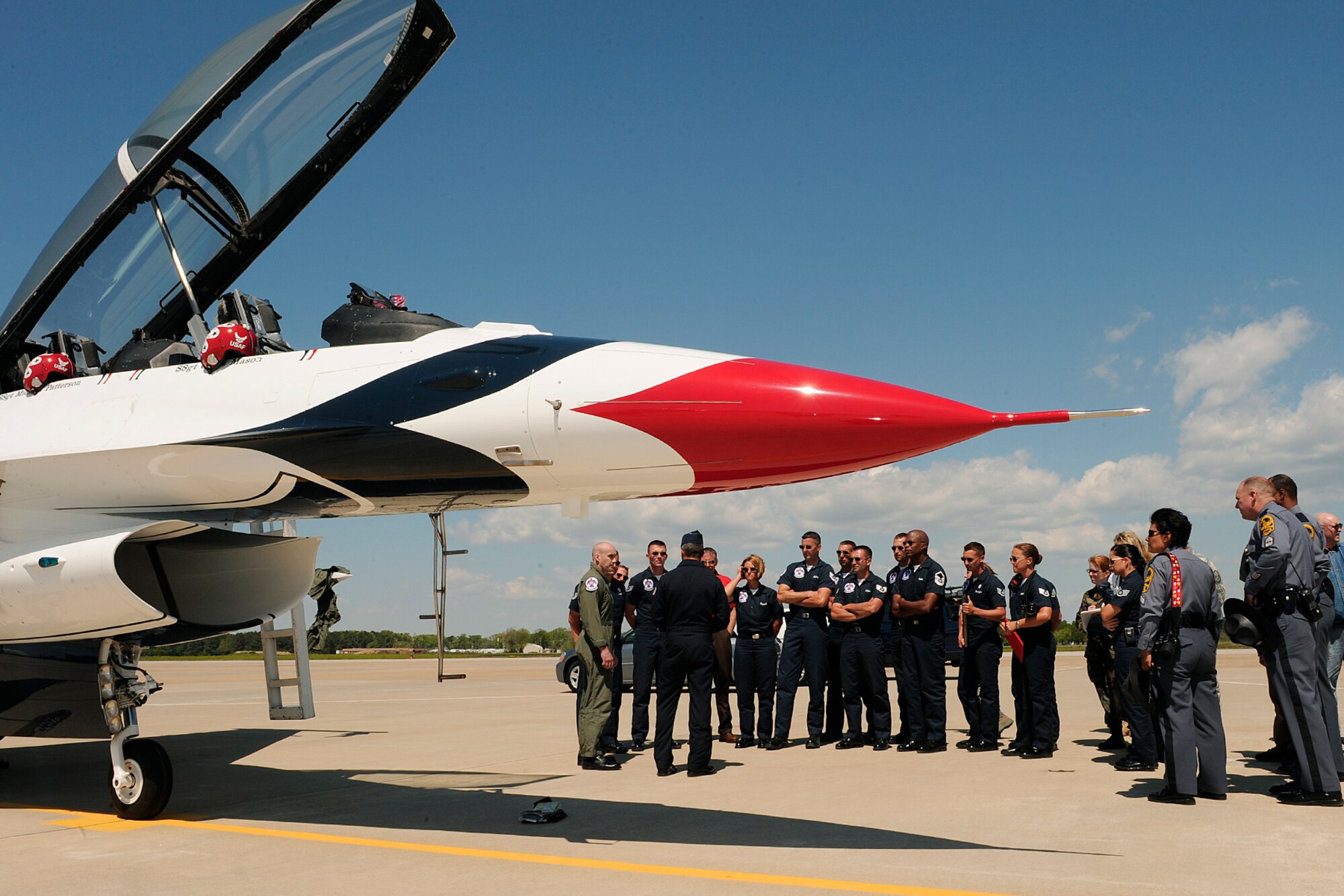 LANGLEY AIR FORCE BASE, Va. -- Maj. Tony Mulhare, Thunderbirds advanced pilot and narrator, speaks with Trooper Kurt Johnson, Virginia State Police, his family and other Troopers after piloting the hometown hero flight here April 23.  Trooper Johnson was awarded a hometown hero certificate along with a flight for saving a little girl from a burning car on her third birthday.  "I didn't even think; if it were one of my sons, I would've done the same thing," said Trooper Johnson.   (U.S. Air Force photo/Senior Airman Vernon Young)