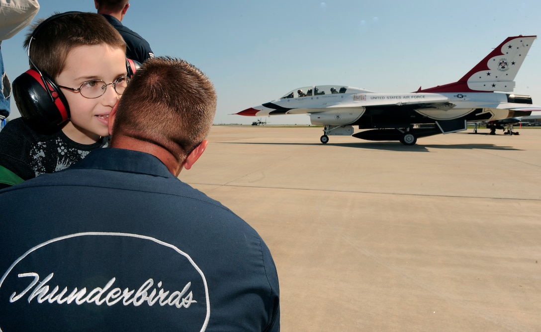 LANGLEY AIR FORCE BASE, Va. --  Branden Johnson talks to Master Sgt. Daniel Lawson, Thunderbirds line chief, prior to his father's hometown hero flight take-off here April 23.   Trooper Kurt Johnson, Virginia State Police, was awarded a hometown hero certificate along with a flight for saving a little girl from a burning car on her third birthday.  "I didn't even think; if it were one of my sons, I would've done the same thing," said Trooper Johnson.   (U.S. Air Force photo/Senior Airman Vernon Young)