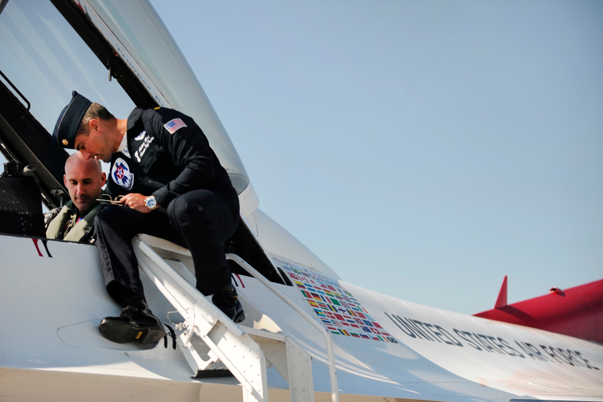LANGLEY AIR FORCE BASE, Va. -- Maj. Tony Mulhare, Thunderbirds advance pilot and narrator, explains the dynamic F-16s model before flying Trooper Kurt Johnson, Virginia State Police, here April 23.  Trooper Johnson was awarded a hometown hero certificate along with a flight for saving a little girl from a burning car on her third birthday.  "I didn't even think; if it were one of my sons, I would've done the same thing."  Trooper Johnson said."   (U.S. Air Force photo/Senior Airman Vernon Young)