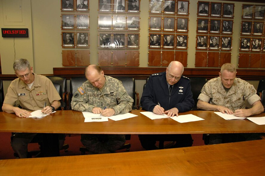 The service logistics chiefs came together at the Pentagon April 13 to sign the Joint Expeditionary Basing Working Group charter. Shown signing the charter are Rear Adm. Thomas Moore, Army Lt. Gen. Mitchell Stevenson, Lt. Gen. Loren Reno and Marine Brig. Gen. David Reist. The goal of the JEBWG is "Achieving commonality and interoperability through joint solutions."  (U.S. Army photo)