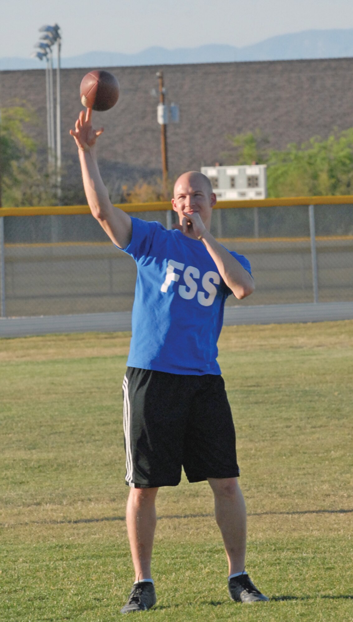 James Goodman tosses a football before an intramural game Tuesday. Goodman is widely regarded as a great leader and teammate by his peers. Despite all of the accolades, Goodman knows that he is not always the best on the field, but continues to stay positive and work toward improving his athletic skills. (U.S. Air Force photo/Senior Airman C.J. Hatch)