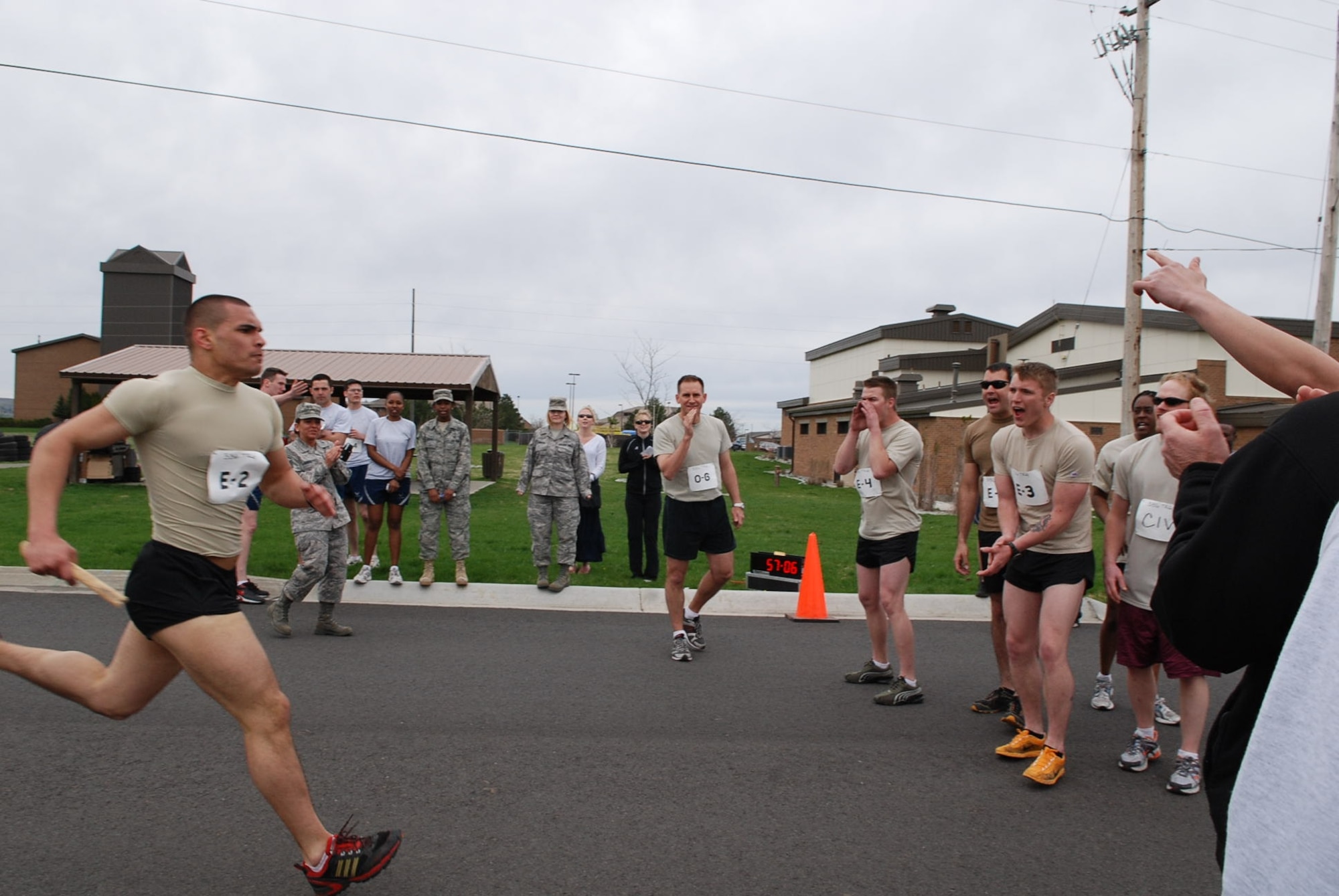 The final member of the SERE relay team completes the Race of the Ranks, taking first place in the contest that took place April 22. The competition included four teams from around Team Fairchild, including the Medical Group, Operations Group, Security Forces and SERE. The teams were composed of all ranks, from O-6 to E-2. (U.S. Air Force photo/Senior Airman Emerald Ralston)