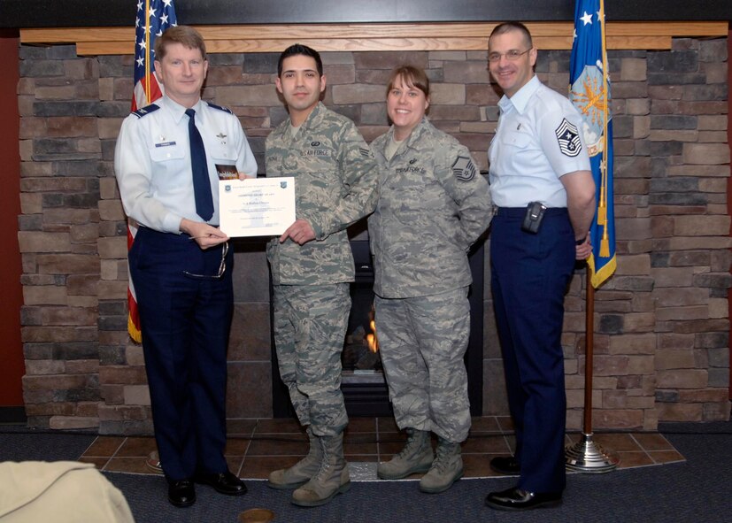 Col. Robert Thomas, 92nd Air Refueling Wing commander, and Chief Master Sgt. David Nordel, 92nd Air Refueling Wing command chief, present the Diamond Sharp award to Senior Airman Ruben Orona, 92nd Comptroller Squadron financial services technician, at the Warrior Dining Facility, April 14. Master Sgt. Michelle Verica, 92nd CPTS quality assurance manager, nominated Airman Orona for his superior costumer service and attention to detail. (U.S. Air Force photo / Airman 1st Class Melissa L. Carlino)