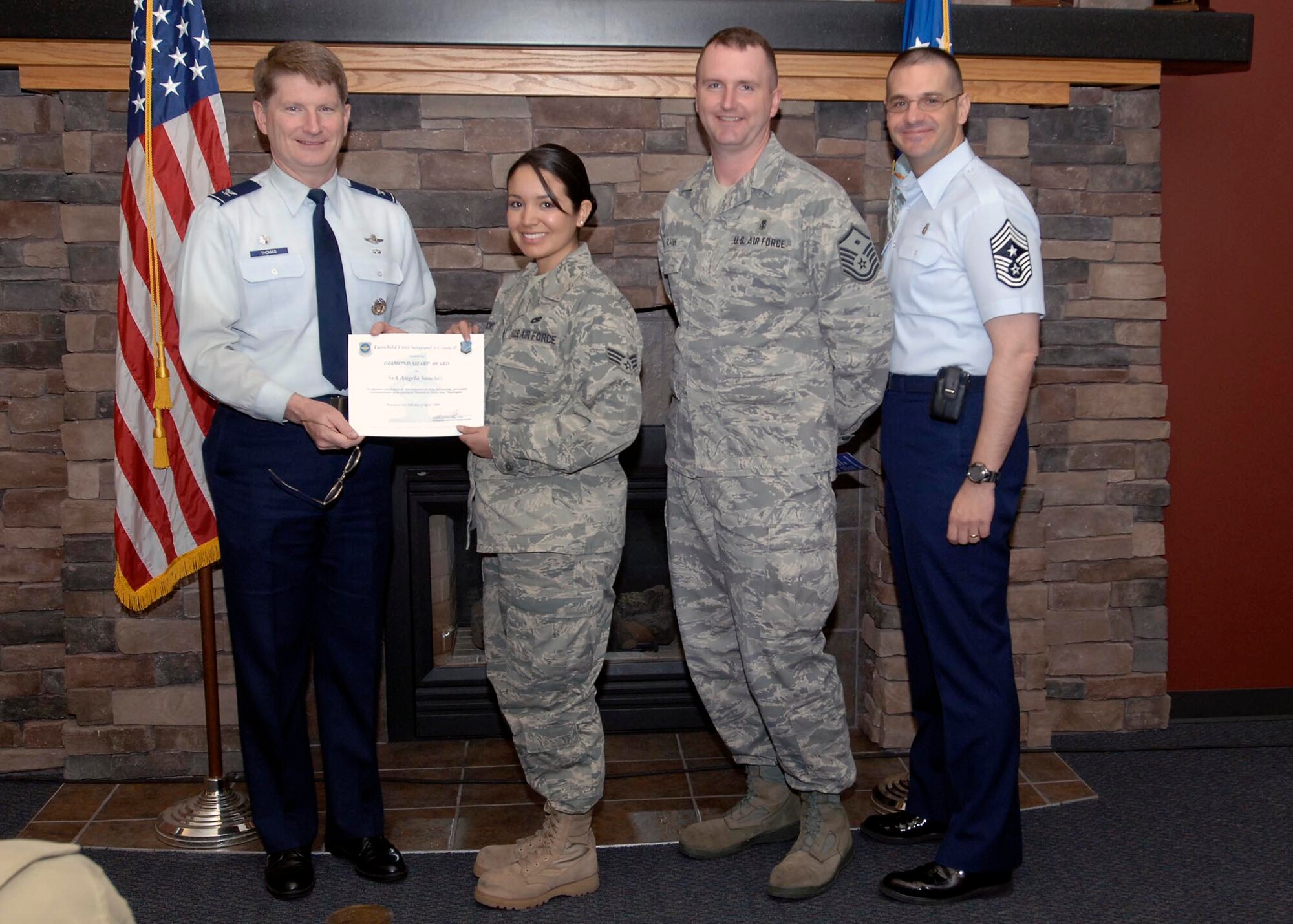 Col. Robert Thomas, 92nd Air Refueling Wing commander, and Chief Master Sgt. David Nordel, 92nd Air Refueling Wing command chief, present Senior Airman Angela Sanchez, 92nd Aircraft Maintenance Group aircraft maintenance de-briefer/technical order distribution officer, with the Diamond Sharp award during breakfast at the Warrior Dining Facility on April 14. Master Sgt. Joe Guzik, 92nd AMXS first sergeant, recognized Airman Sanchez for exemplifying her duties as Dorm Chief and distinguishing herself from her peers. (U.S. Air Force photo / Airman 1st Class Melissa L. Carlino)