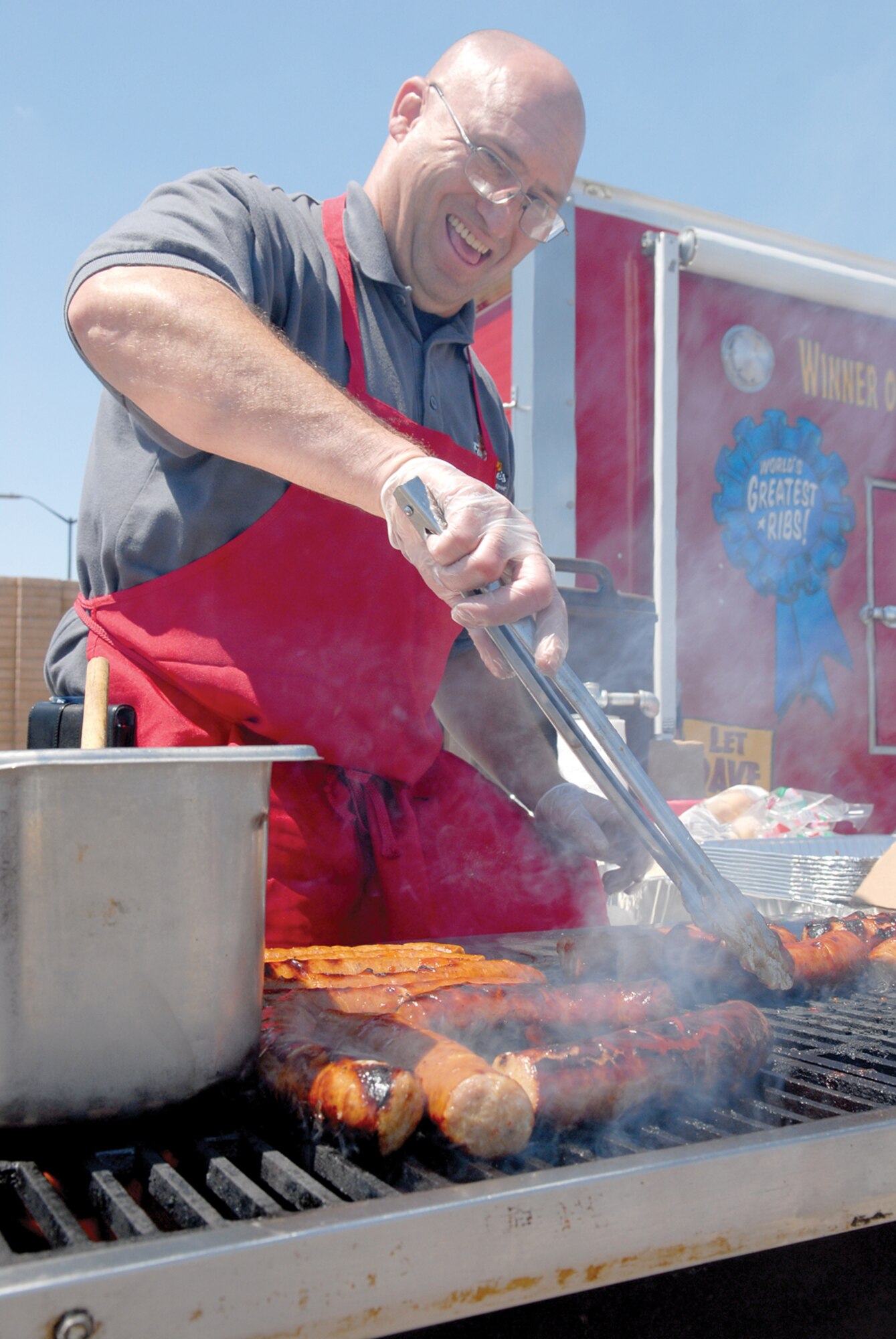 Brian Piersee, kitchen manager at Famous Dave’s, grills up sausage links during a Salute to Military Families NASCAR ticket giveaway April 16 at Luke Air Force Base. (U.S. Air Force photo/ Deborah Silliman Wolfe)