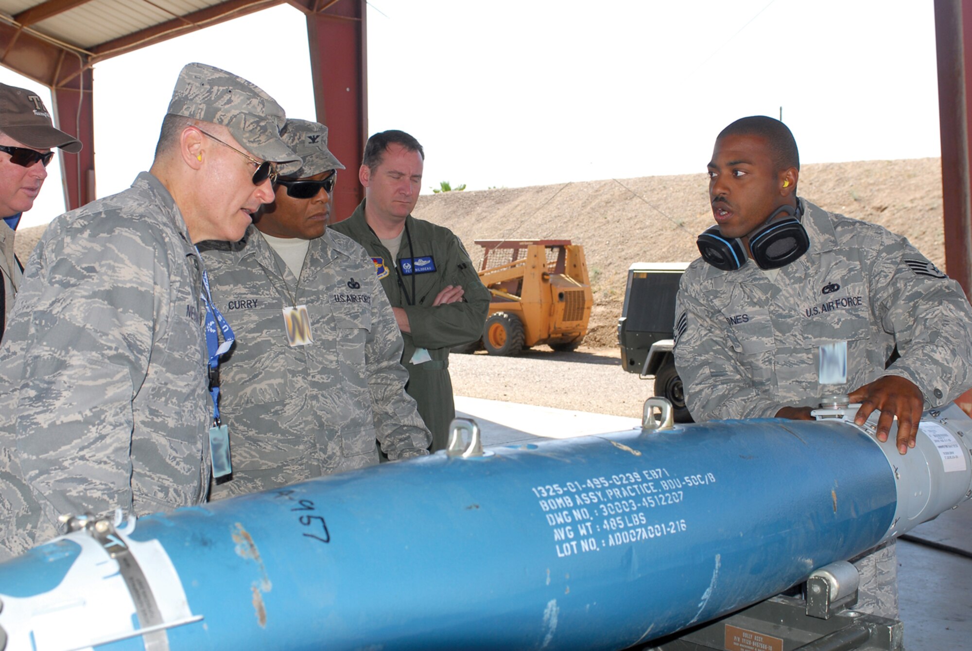 Staff Sgt. Maurice Jones, 56th Equipment Maintenance Squadron munitions systems crew chief, explains the steps to assembling a bomb April 16 to Brig. Gen. Kurt Neubauer, 56th Fighter Wing commander, and Col. Andre Curry, 56th Mission Support Group commander, during their visit to the EMS munitions storage area.  (U.S. Air Force photo/ Airman 1st Class Tracie Forte)