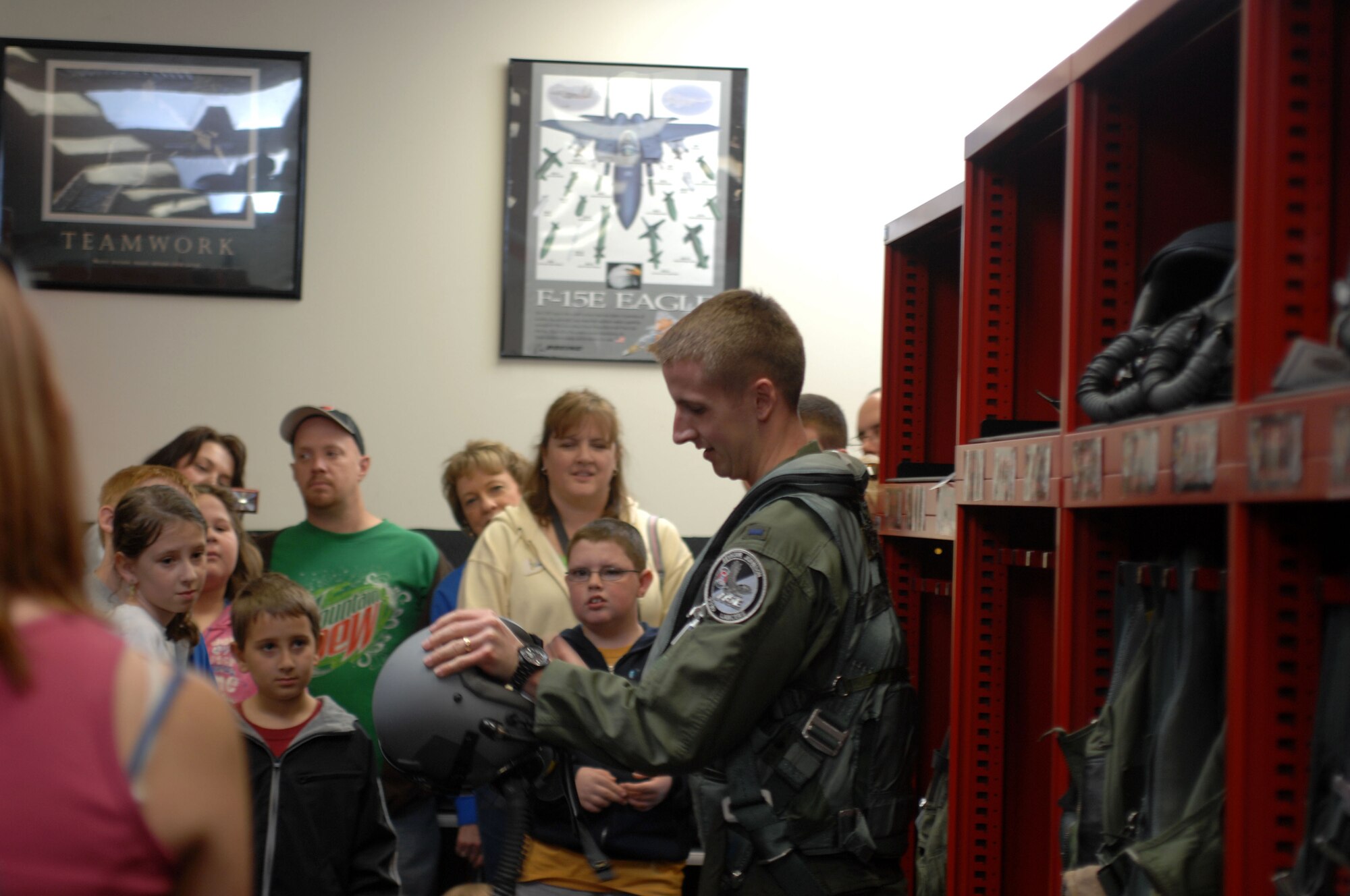 Second Lieutenant Reid Thomas, 333rd Fighter Squadron, shows families how aircrews prepare to fly an F-15E Strike Eagle in the squadron's aircrew flight equipment section at Seymour Johnson Air Force Base, N.C., April 17, 2009.  The visit was sponsored by the Make a Wish Foundation for children with potentially deadly illnesses who dreamed of coming to an air force base. (U.S Air Force Photo by Airman 1st Class Marissa Tucker)