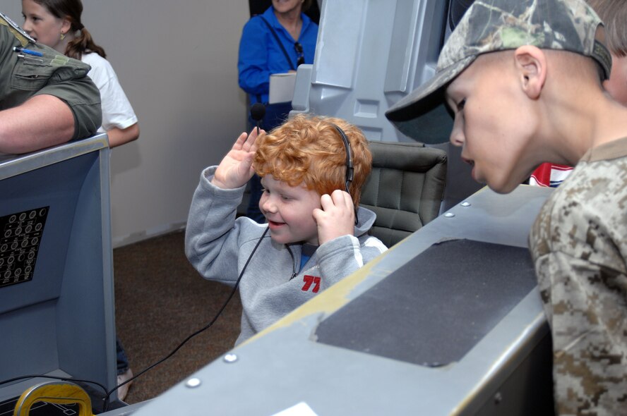 Ian Caldwell, 7, and Joseph Montague, 8, experience a simulated take-off on an F-15E Strike Eagle simulator at the 4th Training Squadron here at Seymour Johnson Air Force Base, N.C., April 17, 2009. The visit was sponsored by the Make a Wish Foundation, which grants wishes to children with life-threatening medical conditions. (U.S. Air Force photo by Airman 1st Class Marissa Tucker)
