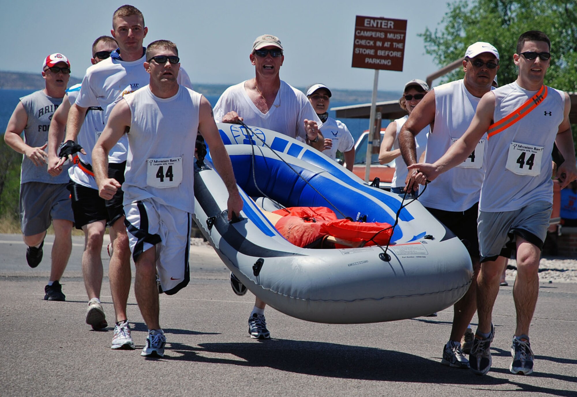 LAUGHLIN AIR FORCE BASE, Texas – The Warhawks, a team from the wing Staff Agency, run while carrying the raft to get to the finish line at the end of the Adventure Race V held here April 18. (U.S. Air Force photo by Airman 1st Class Sara Csurilla)