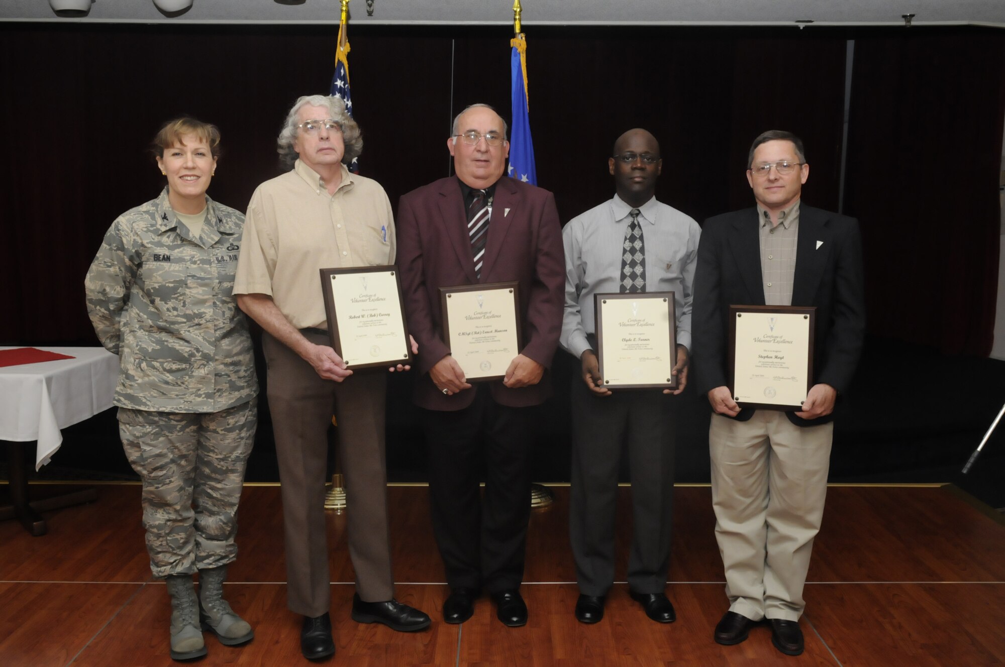 Col. Debra Bean, 78th Air Base Wing vice commander presented Robert Currey, Clyde Turner, Stephen Hoyt, and retired CMSgt Ernest Munson a volunteer excellence award April 22. U. S. Air Force photo by Sue Sapp