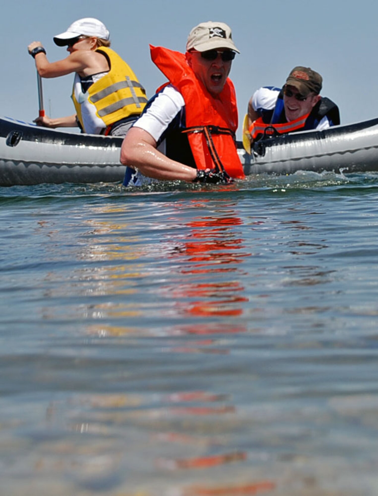 LAUGHLIN AIR FORCE BASE, Texas – One member of a relay team helps pull his raft and other team members to shore after falling out during the 2-mile rafting portion of the 35-mile Adventure Race V held here April 18. (U.S. Air Force photo by Airman 1st Class Sara Csurilla)
