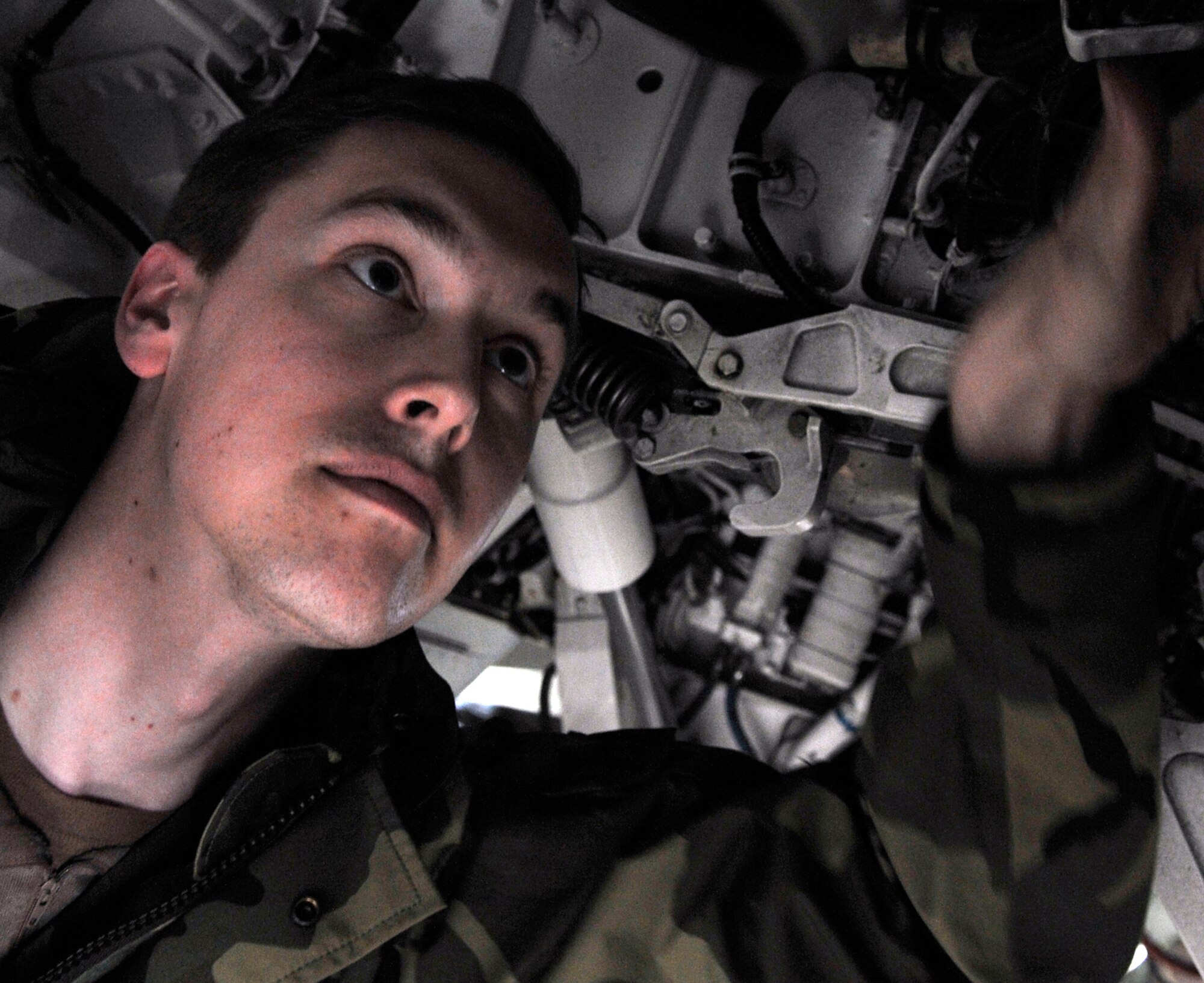 Senior Airman Justin Bauer inspects an F-16 Fighting Falcon April 17 during Red Flag-Alaska at Eielson Air Force Base, Alaska.  Red Flag-Alaska is a Pacific Air Forces-directed field training exercise for U.S. and coalition forces who fly under simulated air-combat conditions. Airman Bauer is an aircraft electrician from the Iowa Air National Guard's 132nd Fighter Wing from Des Moines.  (U.S. Air Force photo/Senior Airman Christopher Boitz) 