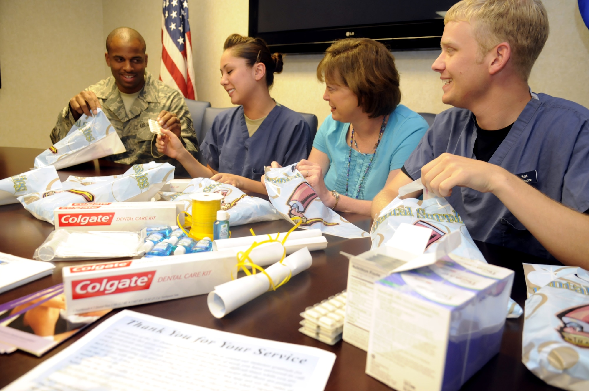 SSgt. Anthony Riley, SrA Mandy Williams, Pam Benbrooks and SrA Tim Gilmore make up the packets that will be distributed to deploying troops. U. S. Air Force photo by Sue Sapp