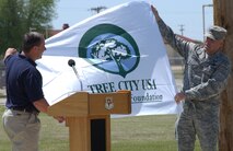 Mr. Dan Stidham, Oklahoma Department of Agriculture forester, and Col. Richard Murphy, 71st Flying Training Wing vice commander, unveil the Tree City U.S.A. flag at the Vance Arbor Day ceremony. 2009 is the 16th consecutive year Vance has been named a Tree City U.S.A. (U.S. Air Force photo by Staff Sgt. Brian Hill)