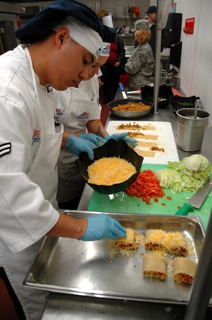 Airmen 1st Class Frank Hernandez and Tanya Cedeno, 341st Force Support Squadron food service specialists, prepare Mexican Chicken Lasagna, which took first place,  during a Warrior Chef Competition April 15 at the Elkhorn Dining Facility. (U.S. Air Force photo/Senior Airman Dillon White)