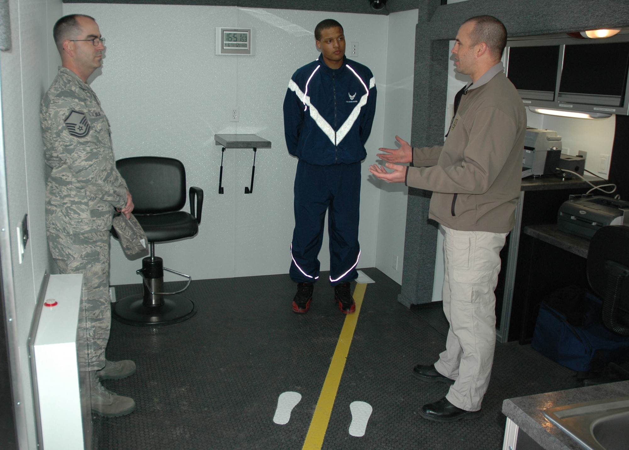 Master Sgt. Rodney Elliot, 341st Missile Wing ground safety office superintendent, and Senior Airman Jermaine Miller, 40th Helicopter Squadron aircrew flight equipment technician, listen to Officer Kurt Sager, Montana Highway patrol trooper, describe the Mobile Impaired Driving Assessment Center and the steps taken when officers conduct standardized field sobriety tests. (U.S. Air Force photo/Senior Airman Dillon White)