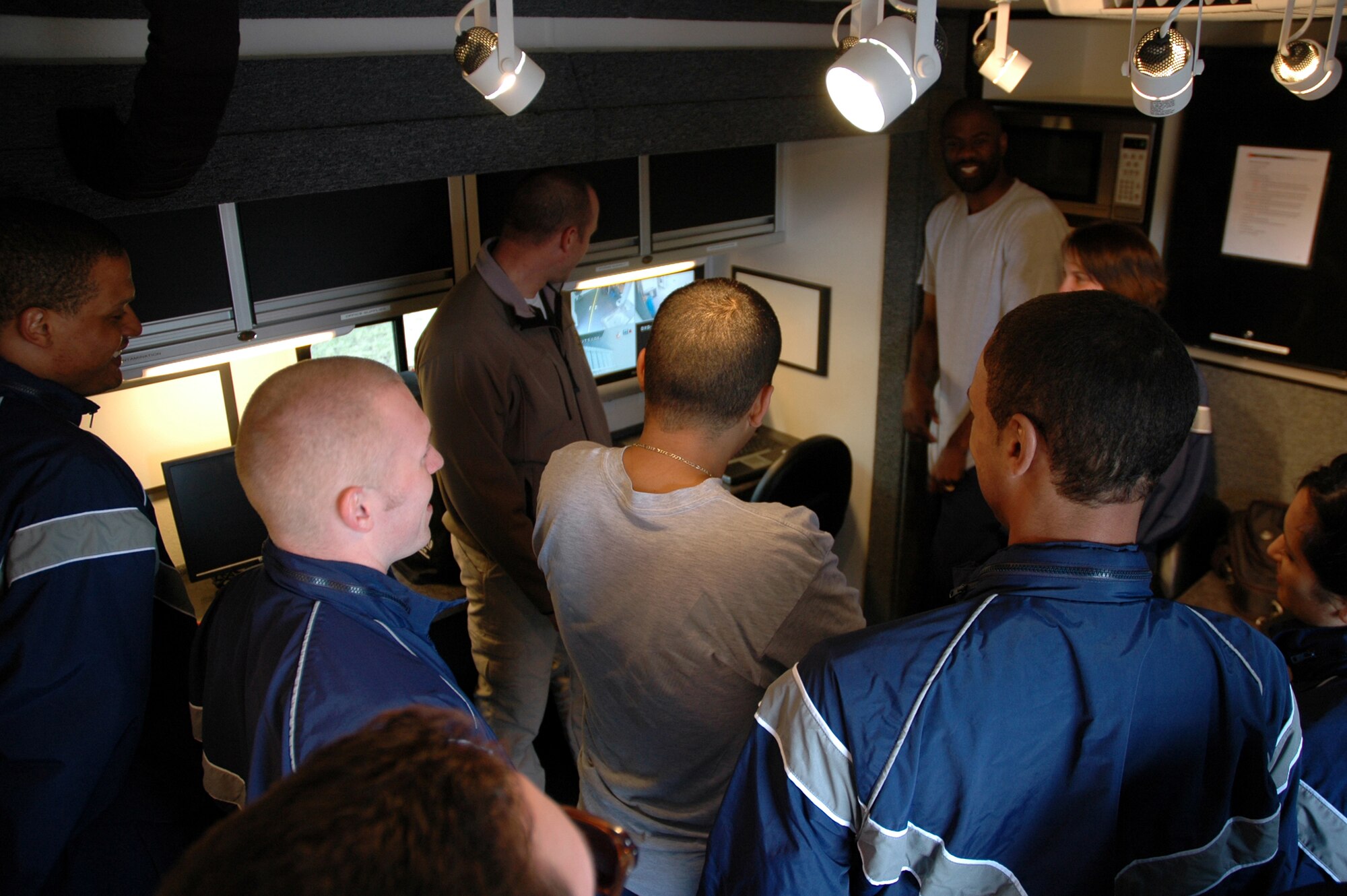 Officer Kurt Sager, Montana Highway Patrol trooper, describes the video-recording capabilities of the Mobile Impaired Driving Assessment Center to a group of Airmen April 16 at Malmstrom. The center was brought to Malmstrom to raise DUI awareness. (U.S. Air Force photo/Senior Airman Dillon White)