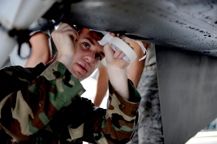 SHAW AIR FORCE BASE, S.C. -- Airman 1st Class Dustin Fink, 79th Fighter Squadron F-16 avionics system apprentice, tapes up panels on an F-16 Fighting Falcon jet during preparation before a wash April 20, 2009. Airmen from the 20th Maintenance Group are participatingin an Air Force Smart Operartions of the 21st Century rapid improvement event to enhance wash rack operations for F-16 aircraft.(U.S. Air Force photo/Senior Airman Matt Davis)