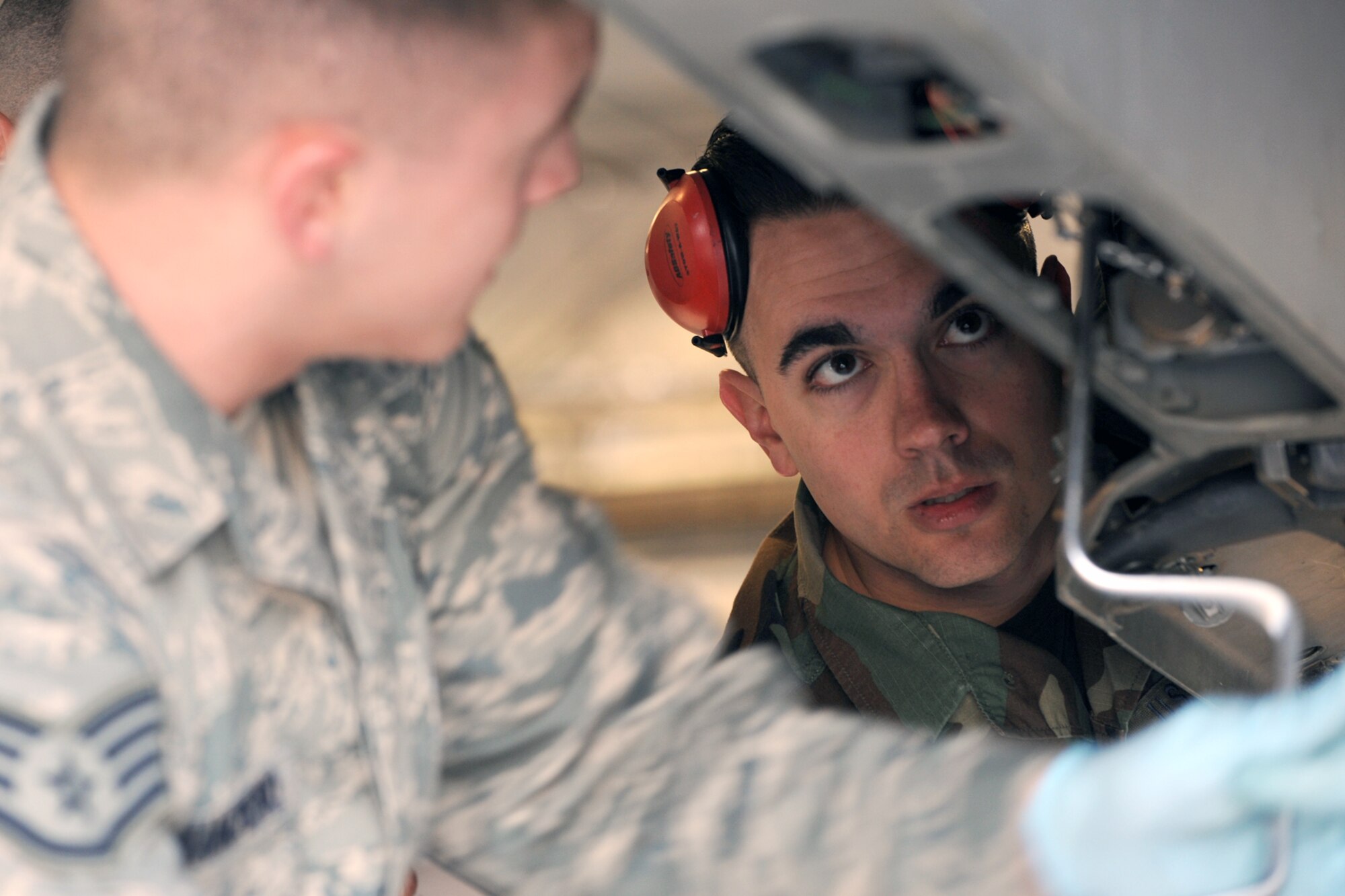 Staff Sgt. Nick Mancheno (left) and Senior Airman Brian Wicker, both 466th Aircraft Maintenance Unit load crew members, secure a weapon under the wing of an F-16 Fighter Falcon during the 388th Fighter Wing's second quarterly Weapons Loading Competition at Hangar 37 April 17. 