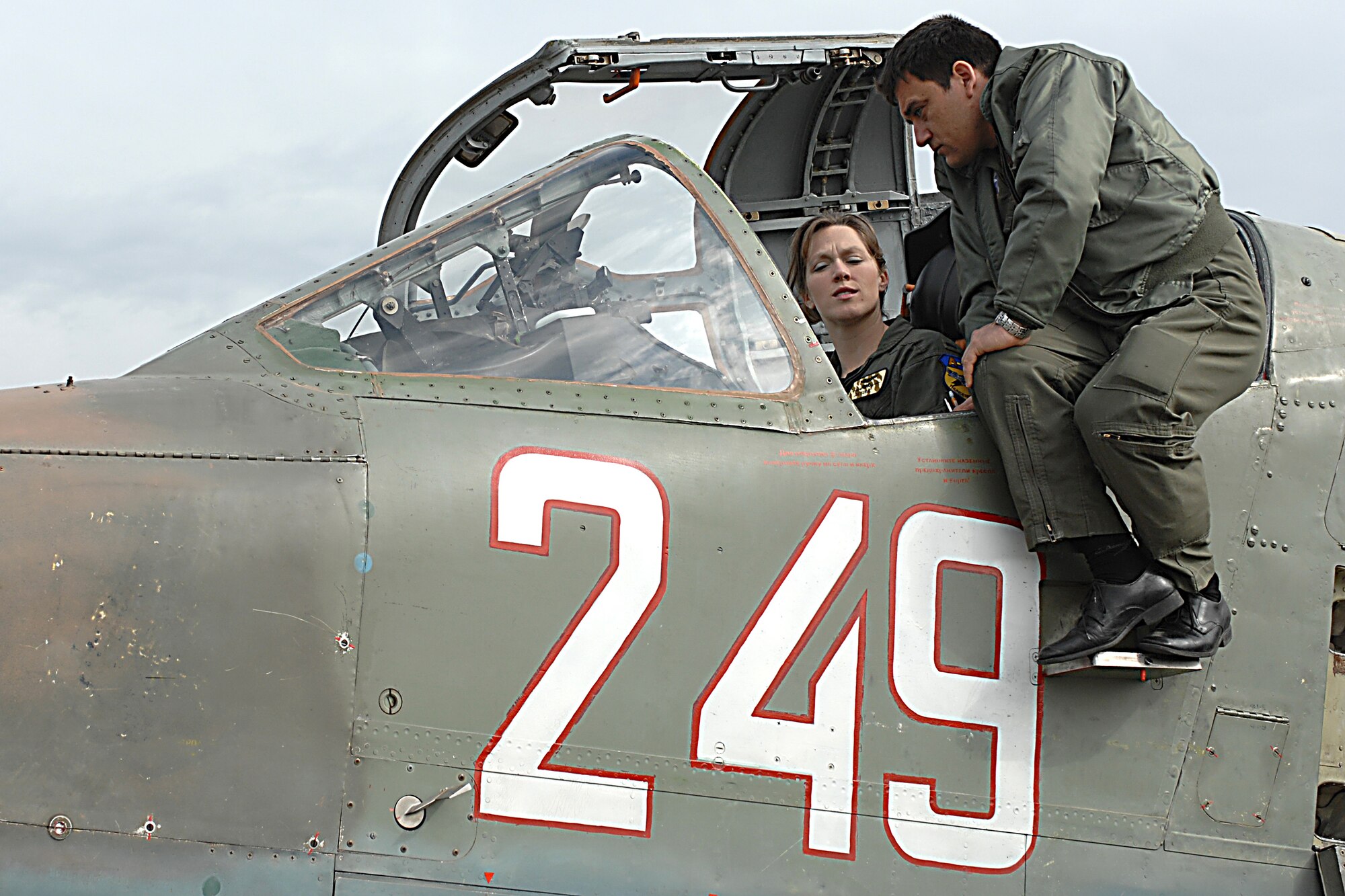 Capt. Vladislav Todorov, a Bulgarian SU-25 pilot, explains the SU-25 cockpit April 15 to Air Force 1st Lt. Priscilla Giddings, an A-10 pilot from the 81st Fighter Squadron. Pilots from Spandahlem Air Base, Germany, and the Bulgarian air force joined together during "Reunion April 2009" to hone their close air support capabilities. (U.S. Air Force photo/Master Sgt. Bill Gomez) 