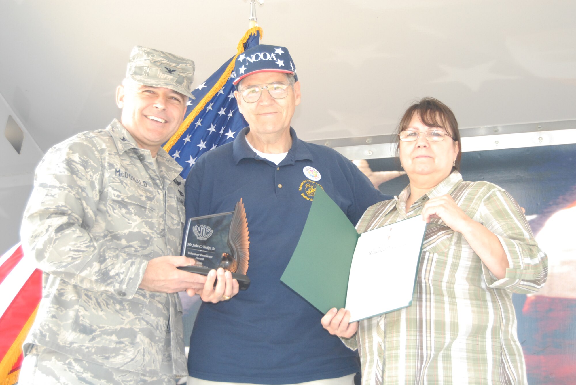 Col. John McDonald, 43rd Airlift Wing Commander and Mrs. Darlene Renteria, 43rd Force Support Squadron Airman and Family Readiness Center Volunteer Coordinator, present the 2008 Pope Volunteer Excellence Award to John Tucker Jr. April 21. Mr. Tucker donated more than 2,700 hours to Pope and the surrounding communities in 2008. (U.S. Air Force Photo by Tech. Sgt. Todd Wivell)