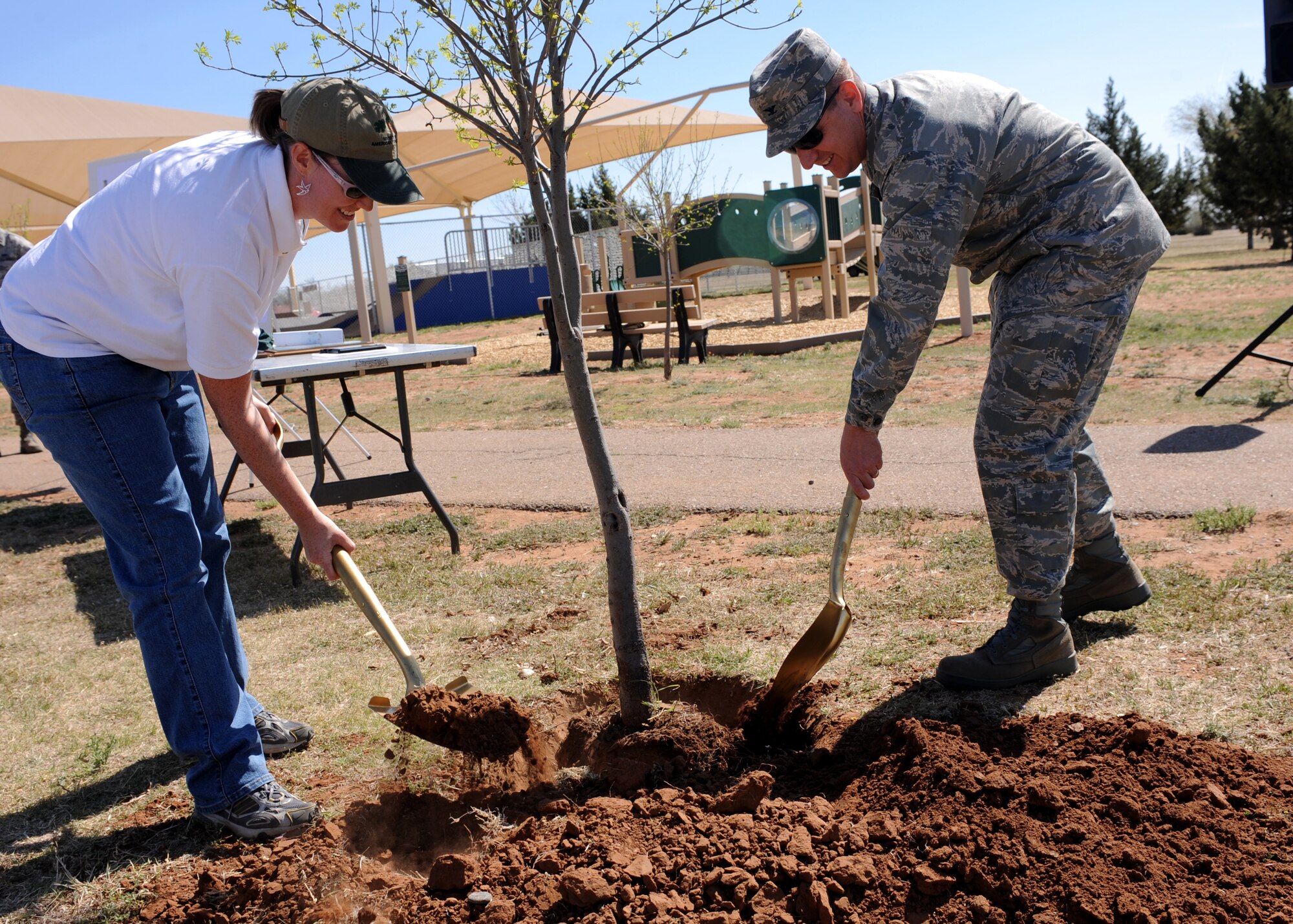 CANNON AIR FORCE BASE, N.M. -- Shannon Atencio, Las Vegas District Forestry Department, and Col. Ruedi Kaspar, 27th Special Operations Wing vice commander, plant a tree at Doc Stewart Park here April 22. The Arbor Day Foundation named Cannon as a 2009 Tree City USA community and presented Cannon with its first Growth Award. The 27th Special Operations Civil Engineer Squadron Natural Resources Management Flight hosted numerous Arbor Day events  from April 16-23. (U.S. Air Force Photo/Airman 1st Class Evelyn Chavez)
