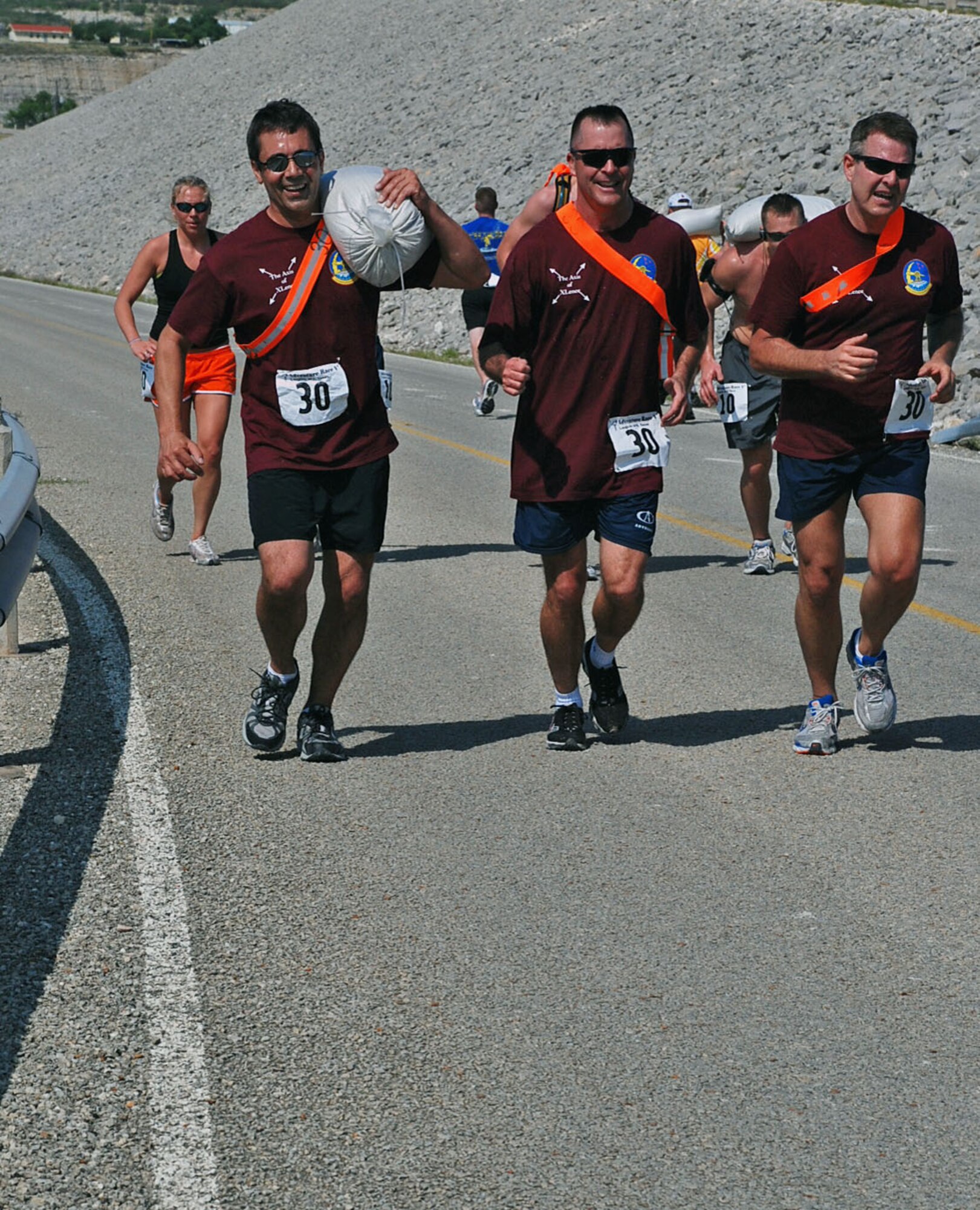 LAUGHLIN AIR FORCE BASE, Texas -- Chief Craig Wilgus, Laughlin Fire Department, Col. Andrew Cernicky, 47th Mission Support Group commander and William Daufen, communications plans and resources flight chief, run up a steep hill next to Lake Amistad during the 7-mile run portion of Adventure Race V April 18. (U.S. Air Force photo by Airman 1st Class Sara Csurilla)