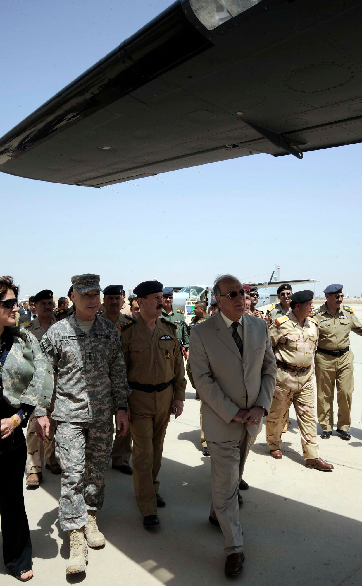 Lt. Gen. Frank Helmick, Mulit-National Security Transition Command-Iraq commanding general (left); Abd al-Qadir al-Mufriji, Iraqi Minister of Defense and others tour the Iraqi aircraft static display area April 22 during the 78th annual Iraqi Air Day at New al-Muthana Air Base, Iraq. U.S. Air Force Airman and Iraqi military members attended the event to celebrate how far the Iraqi air force has come in the past few years.   (U.S. Air Force photo/Senior Airman Jacqueline Romero)
