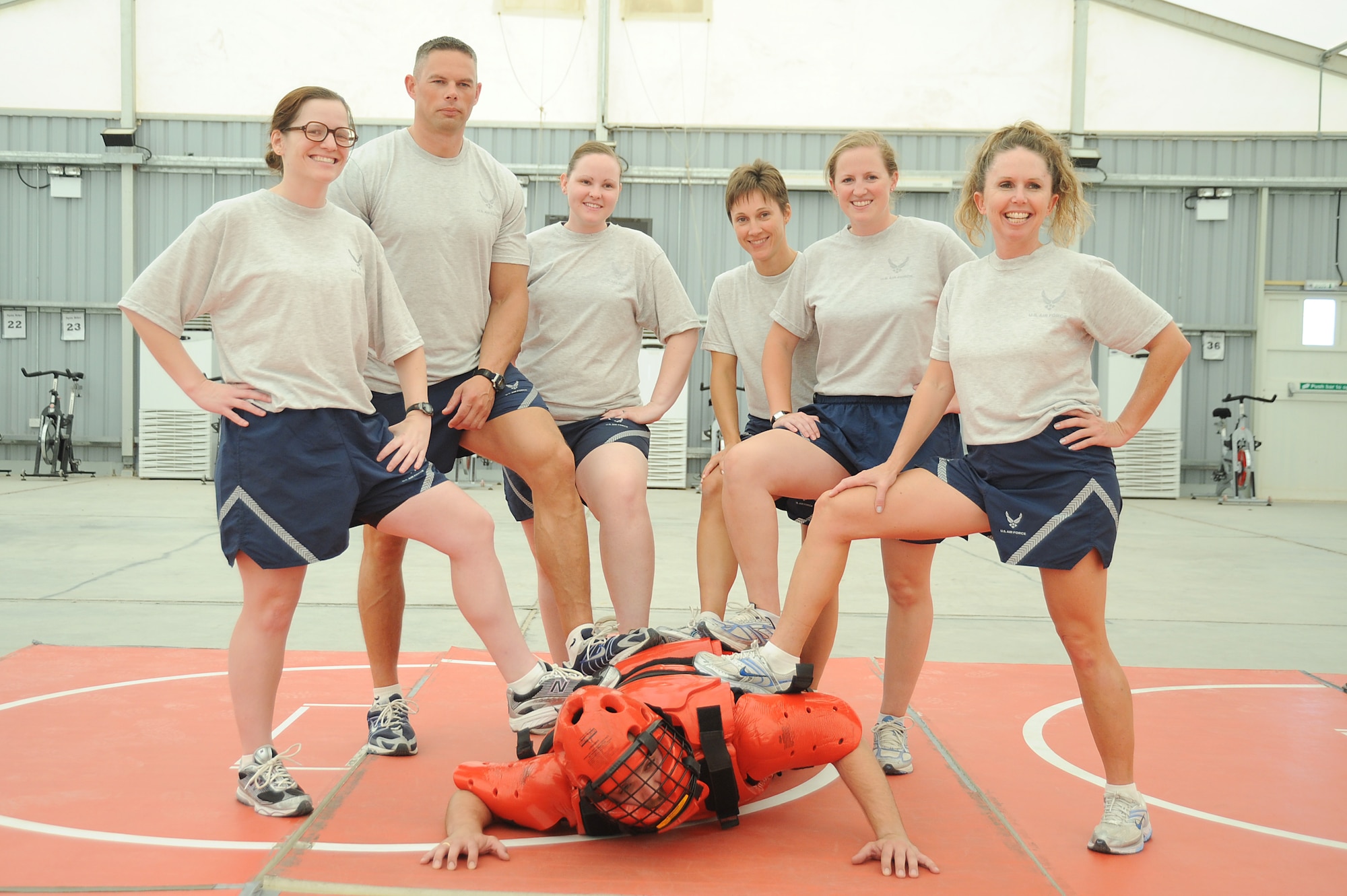 Instructors Tech. Sgt. Rob Goddard, 380th Expeditionary Security Forces Squadron (2nd from the left) and Mr. Rick Baldwin, a Northrop Grumman contractor (red man suit) pose with their students after a self-defense training class, April 18 at an undisclosed location in Southwest Asia. The Sexual Assault Response Coordinator (SARC) sponsored the training that gave students the chance to learn techniques to defend themselves from attack. Sergeant Goddard is deployed from Eglin AFB, Fla. and hails from Harrisville, Mich. (U.S. Air Force photo by Senior Airman Brian J. Ellis) (Released)