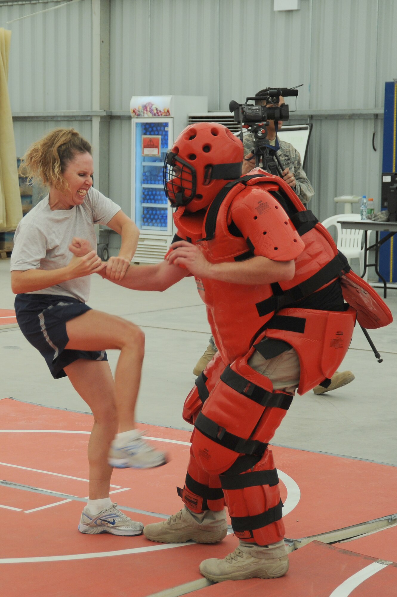 Capt. Sherry Souriolle, 380th Air Expeditionary Wing, Sexual Assault Response Coordinator, prepares to give a kick to the groin of an attacker played by Mr. Rick Baldwin, a Northrop Grumman contractor during self-defense training, April 18 at an undisclosed location in Southwest Asia. The Sexual Assault Response Coordinator (SARC) sponsored the training that gave students the chance to learn techniques to defend themselves from attack. Captain Souriolle is deployed from Los Angeles AFB, Calif. and hails from San Diego, Calif. (U.S. Air Force photo by Senior Airman Brian J. Ellis) (Released)